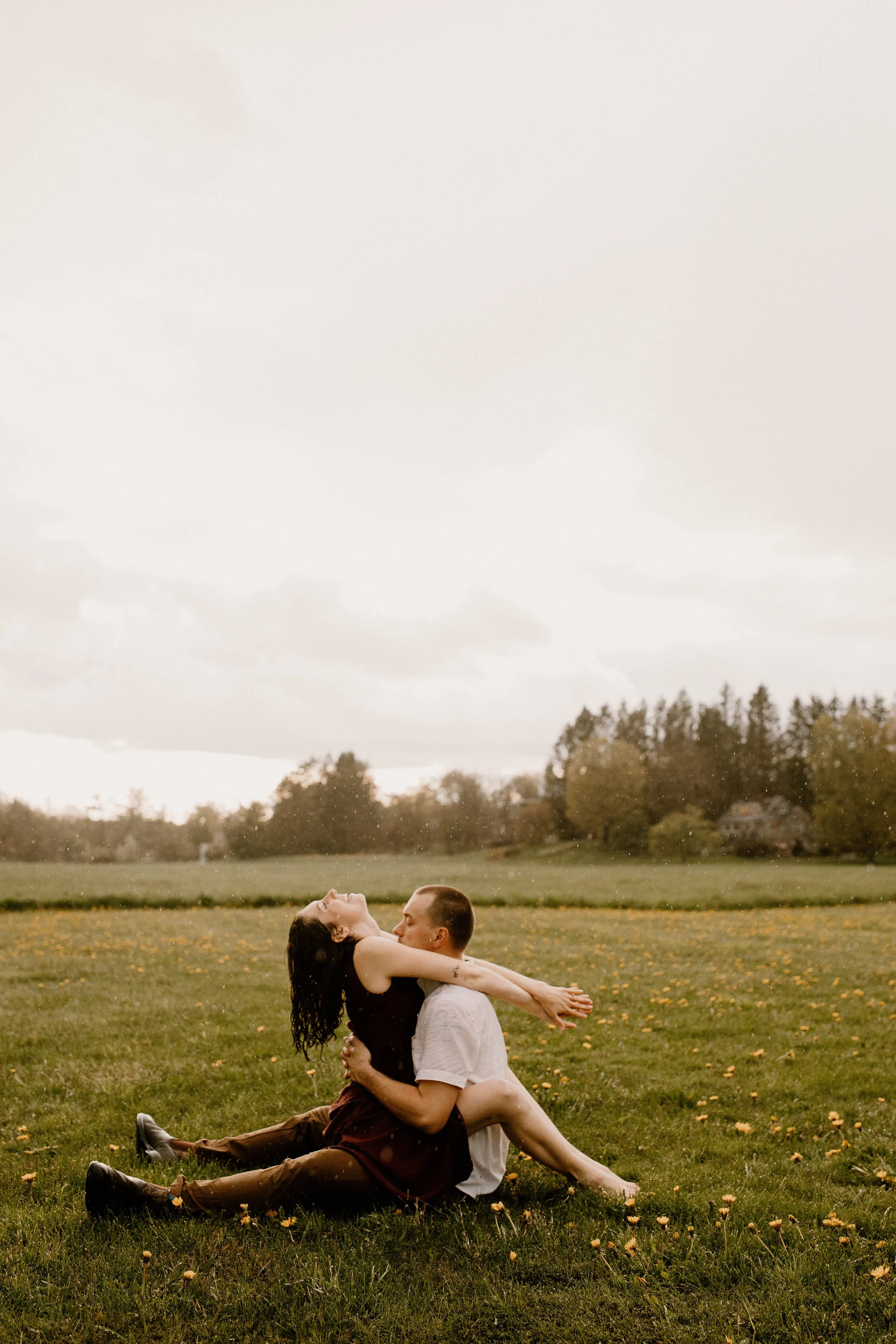 A Massachusetts couple dance in the rain during their engagement photos.