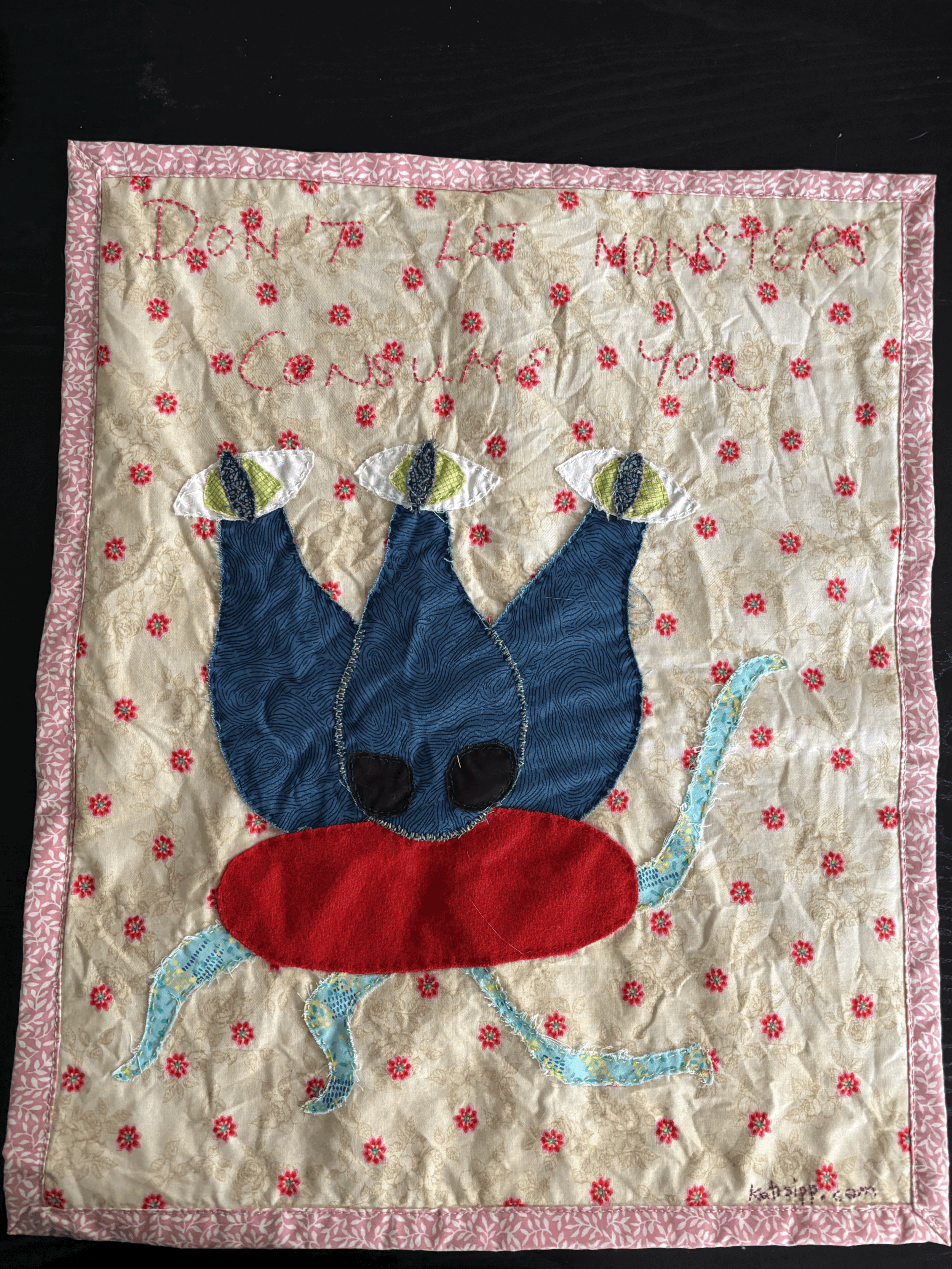 "Don't Let Monsters Consume You" fabric wall hanging