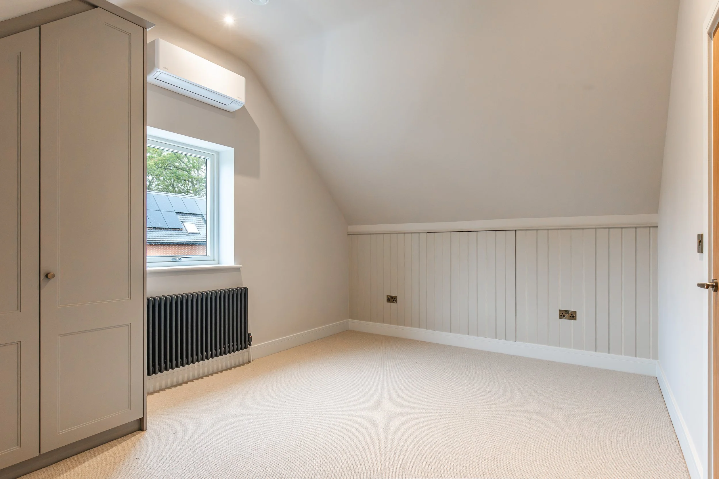 top floor bedroom with eaves storage and fitted furniture.