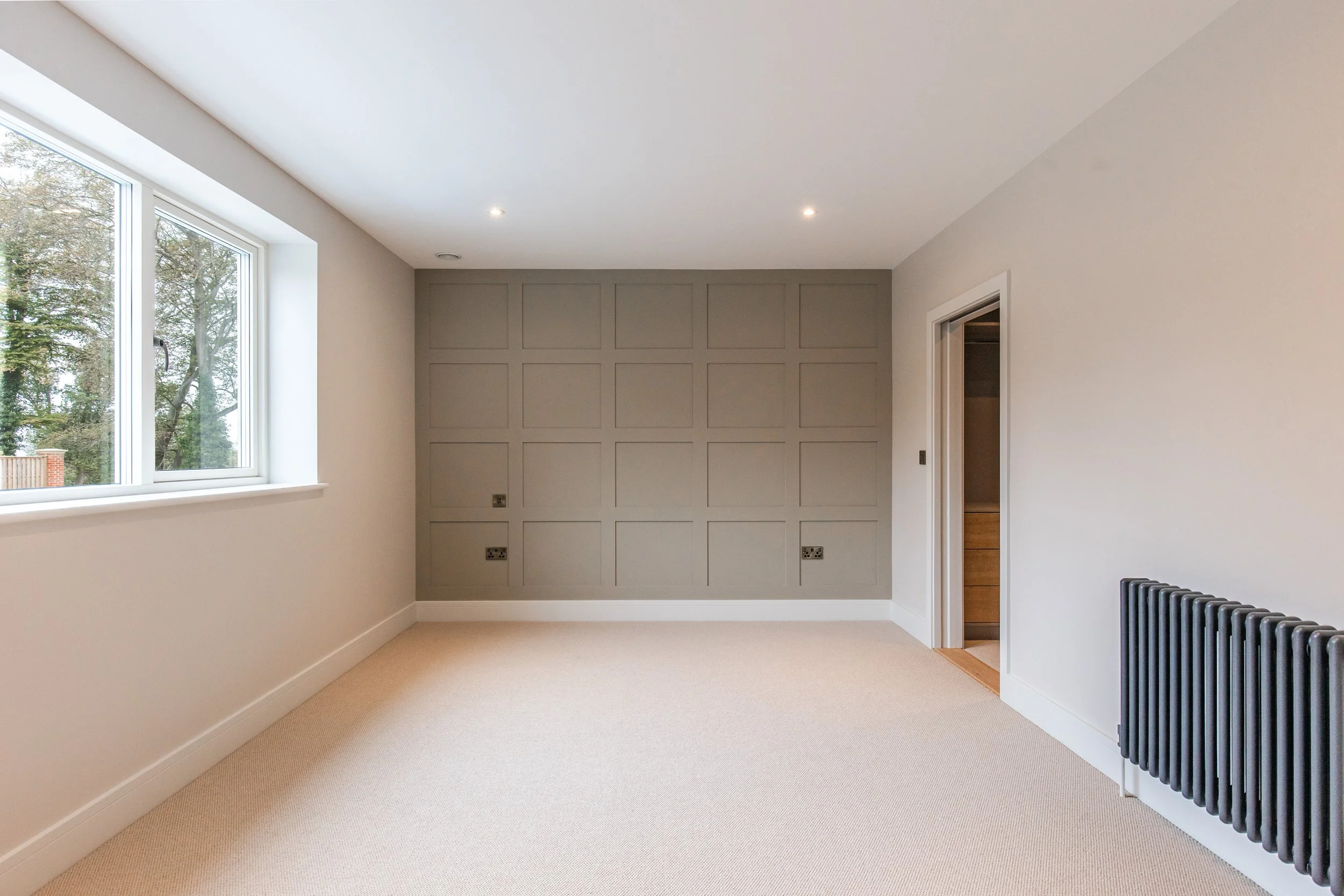 Principal bedroom with panelled bedhead wall
