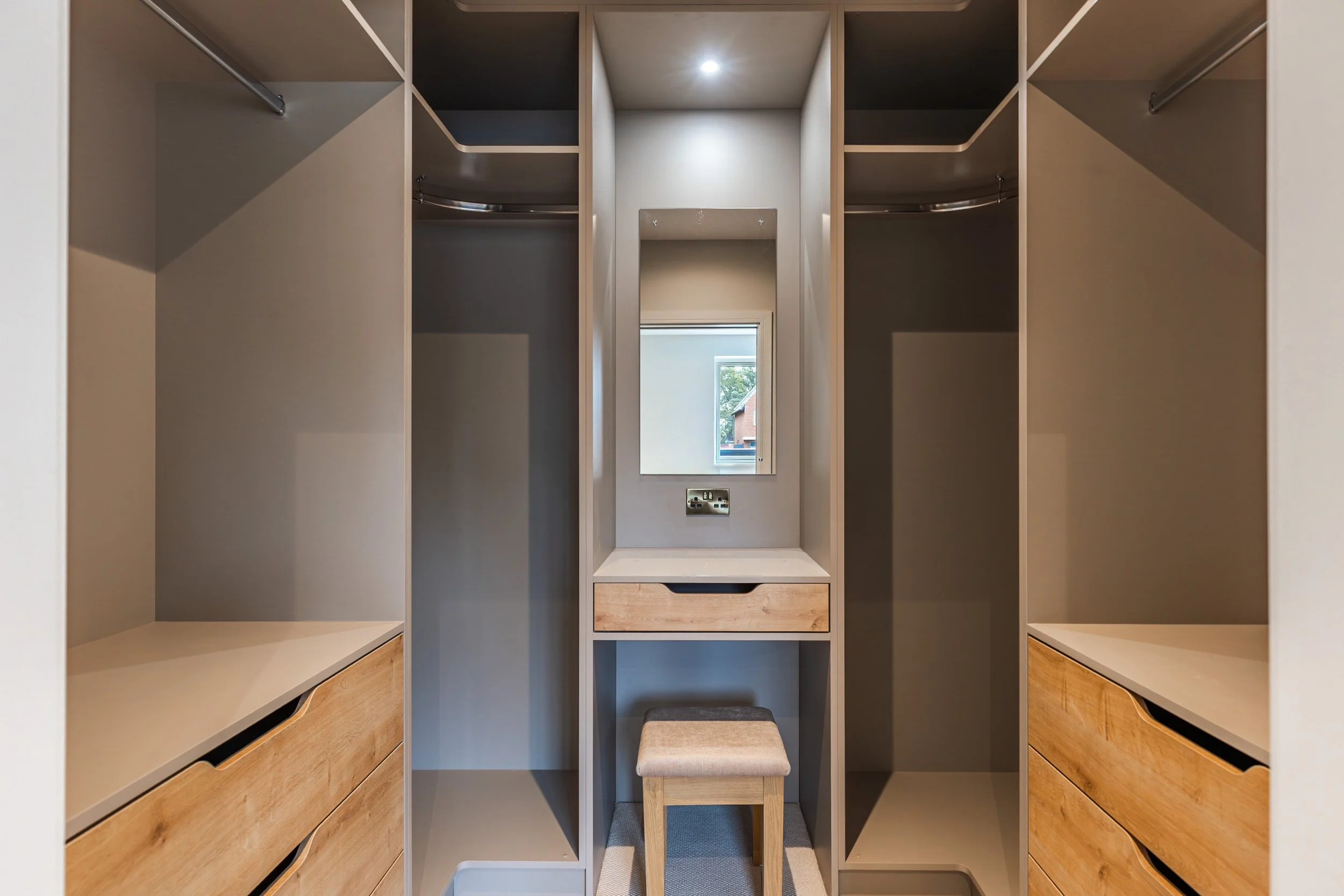 Walk-in dressing room with bespoke fitted furniture