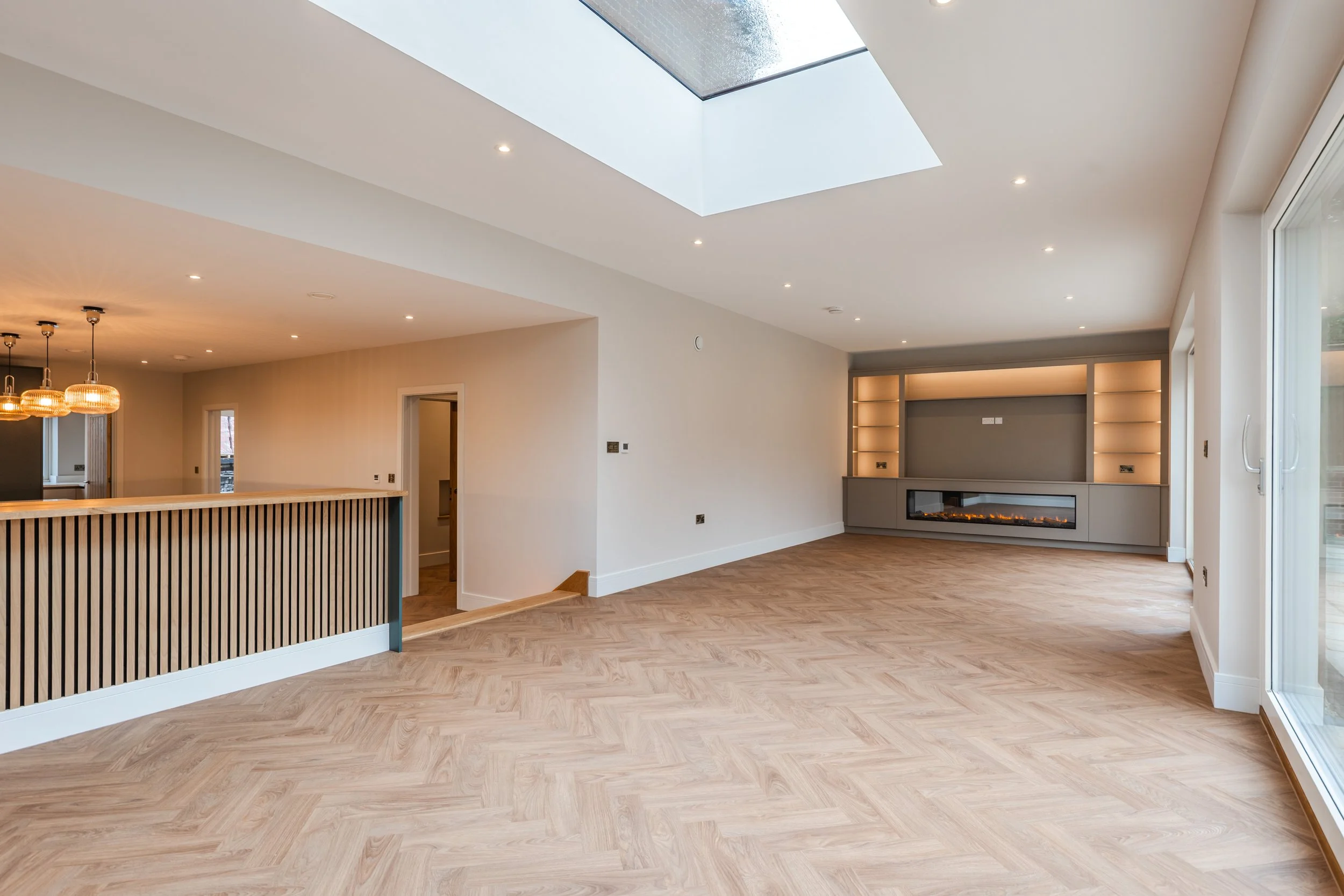 Upper level dining room and living room with bespoke media unit.