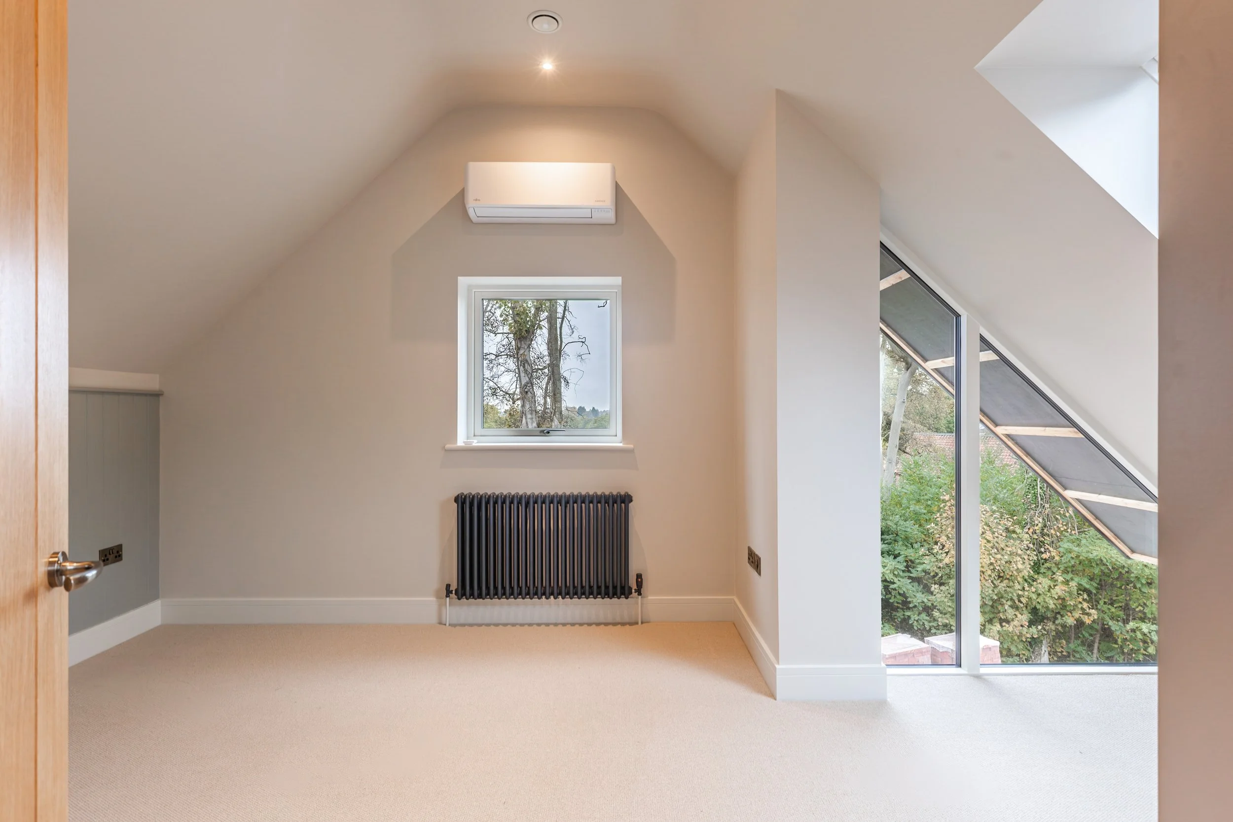 Top floor bedroom completed with corner glazing. 