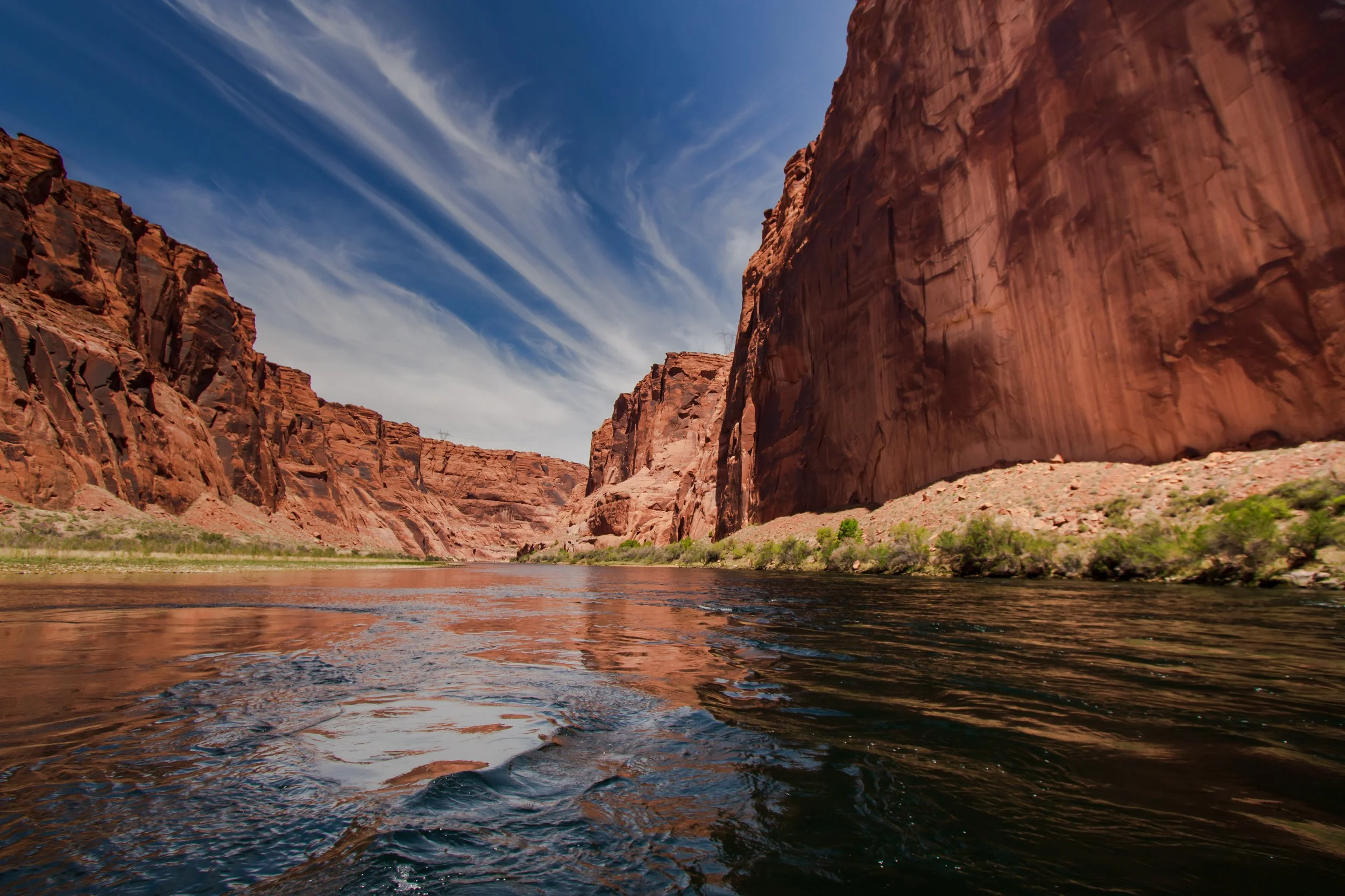 Calm water in Moab surrounded by red rocks
