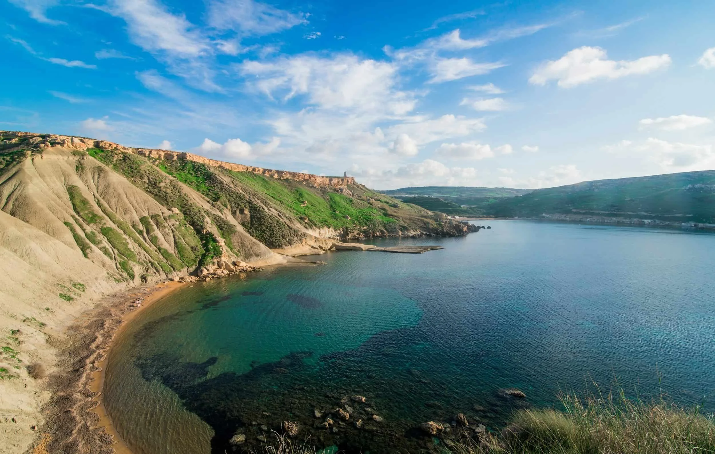 Beautiful bay with clay slopes ready to be explored by those who move to Malta.