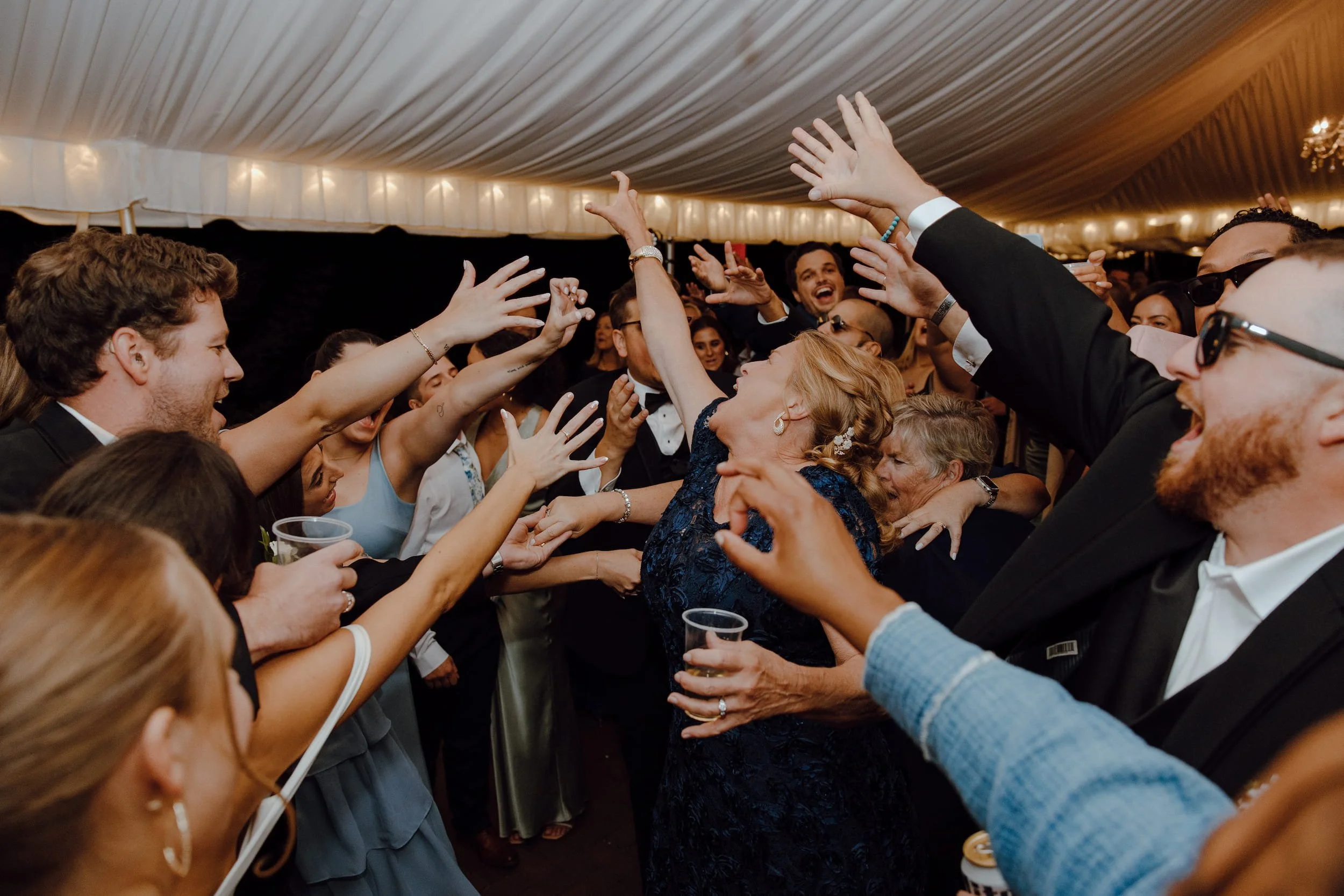 Guests dancing and laughing at wedding at the William Paca House & Garden in Annapolis, Maryland