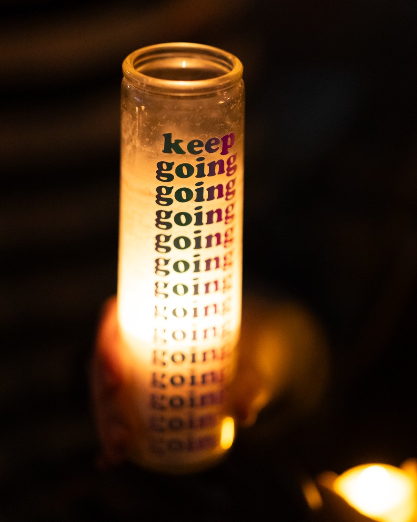 It has been three months, but Nex, we're still carrying your light. 

Photo by Lauren Smith at an Oklahoma City vigil for Nex Benedict. 

ID: photo of a lit cylindrical candle with text &quot;Keep going&quot; with the word going repeating several tim