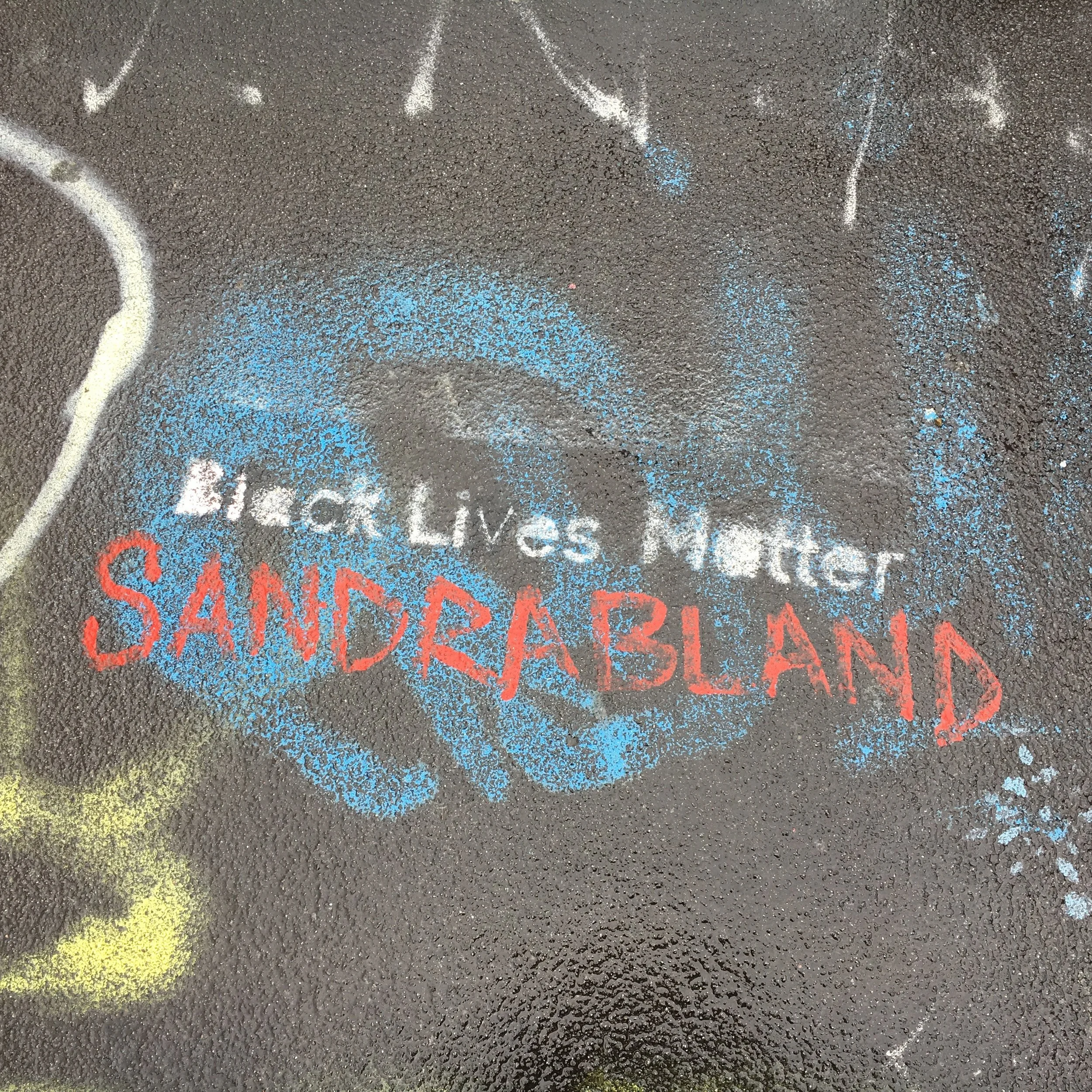 Street art with text "Black Lives Matter Sandra Bland"