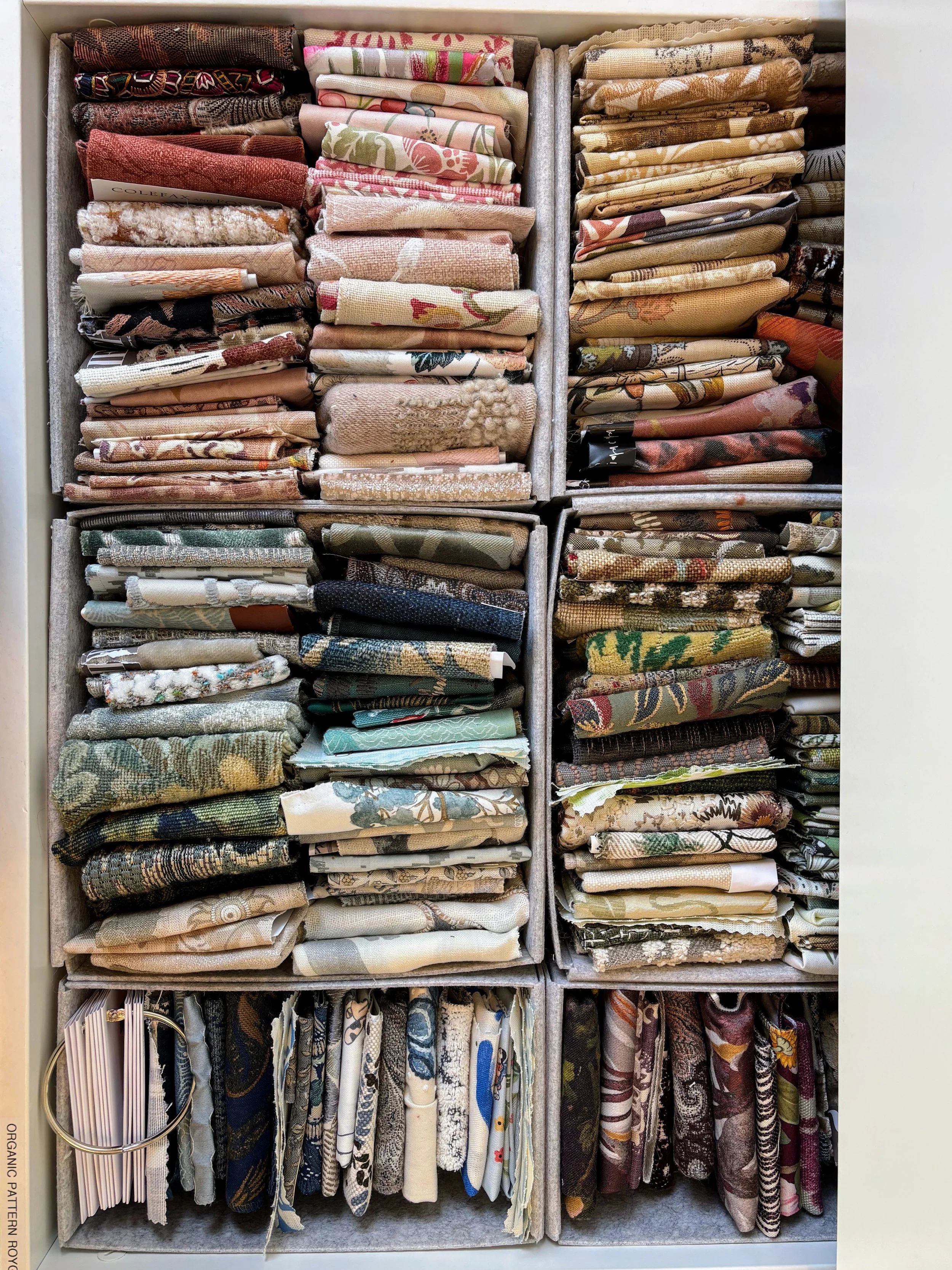CRS Library clients' storage organizer filled with folded fabric swatches and textiles in various colors and patterns.