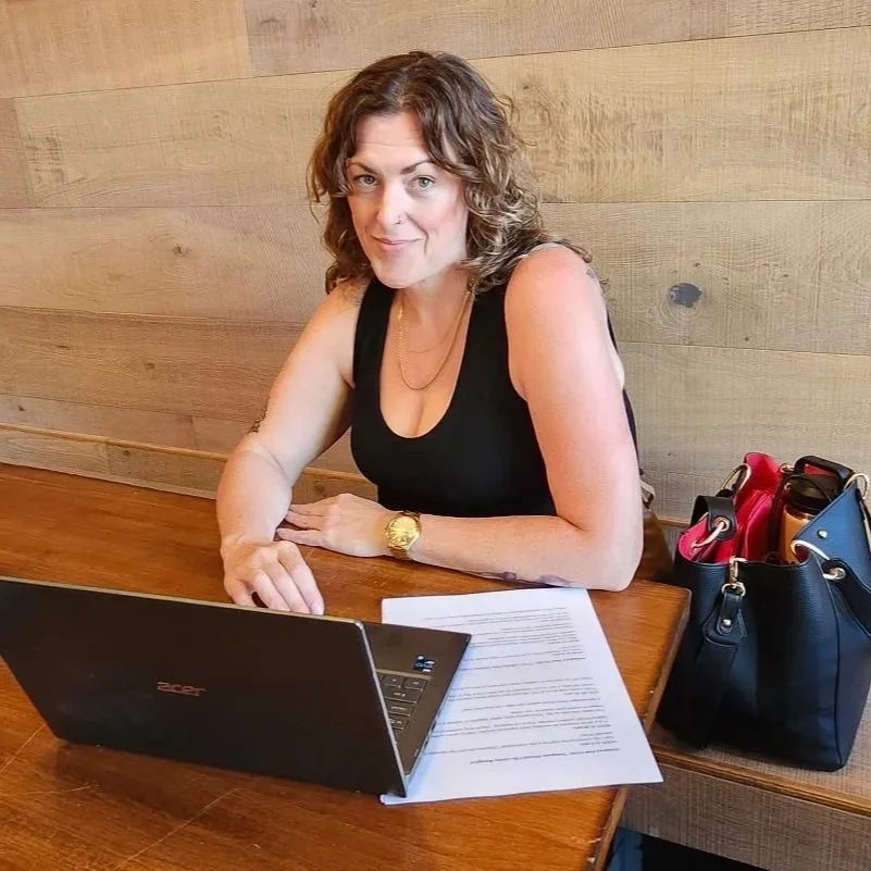 Claire Mattingly, founder of CRS Library, is working on her laptop.