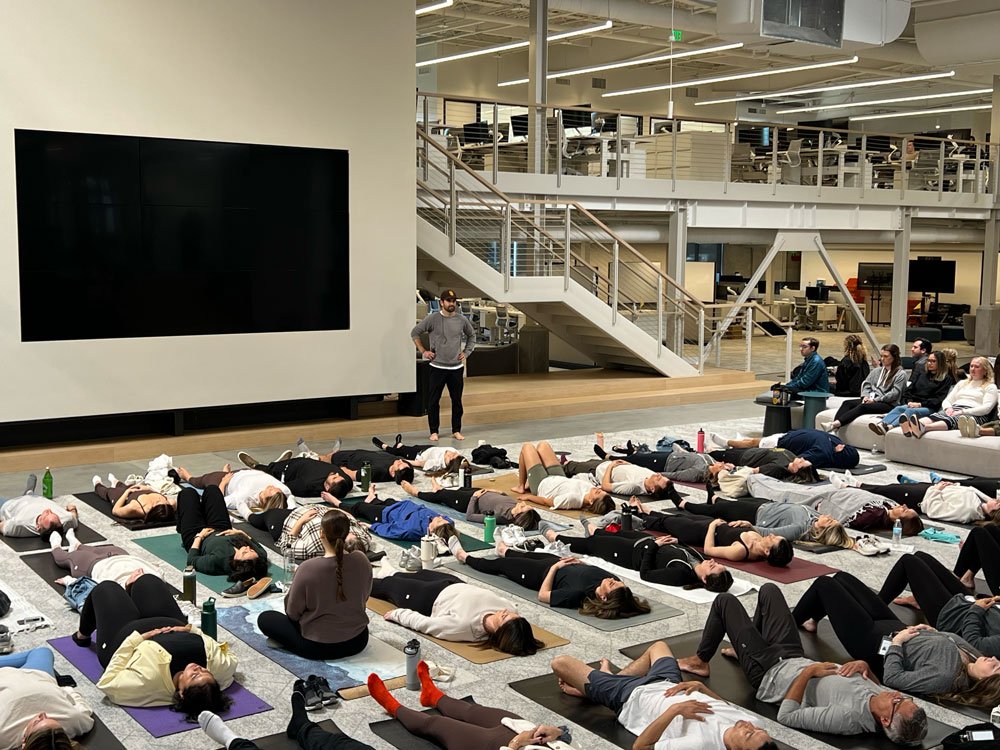 Reis guiding breathwork for the entire staff at Vuori Headquarters