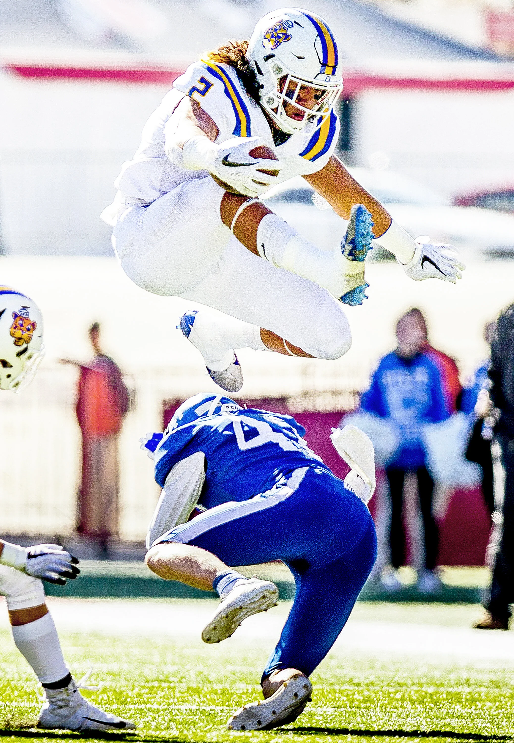 Orem running back Noah Sewell (2) hurdles Dixie free safety Harrison Beazer (47), but officials called a penalty during the play, in the 4A football state championship game between the Orem Golden Tigers and the Dixie Flyers held Friday, Nov. 16, 201