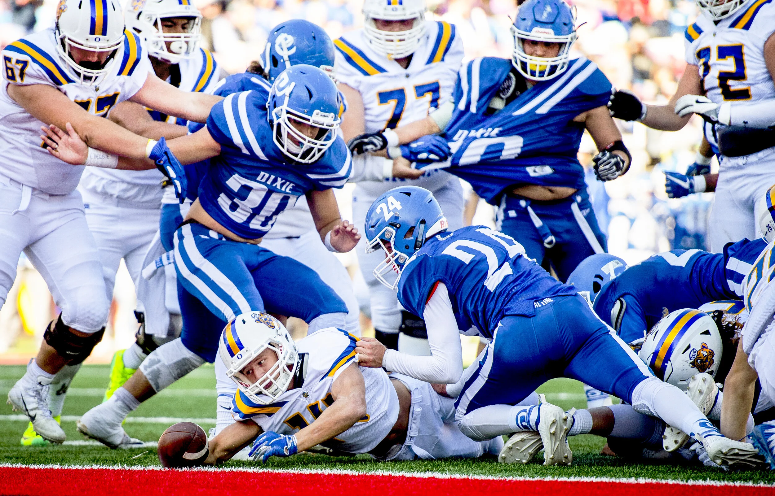 Orem running back Trevor Rockey (14) is downed just short of the goal line by Dixie defenders during the 4A football state championship game between the Orem Golden Tigers and the Dixie Flyers held Friday, Nov. 16, 2018, at Rice-Eccles Stadium in Sal