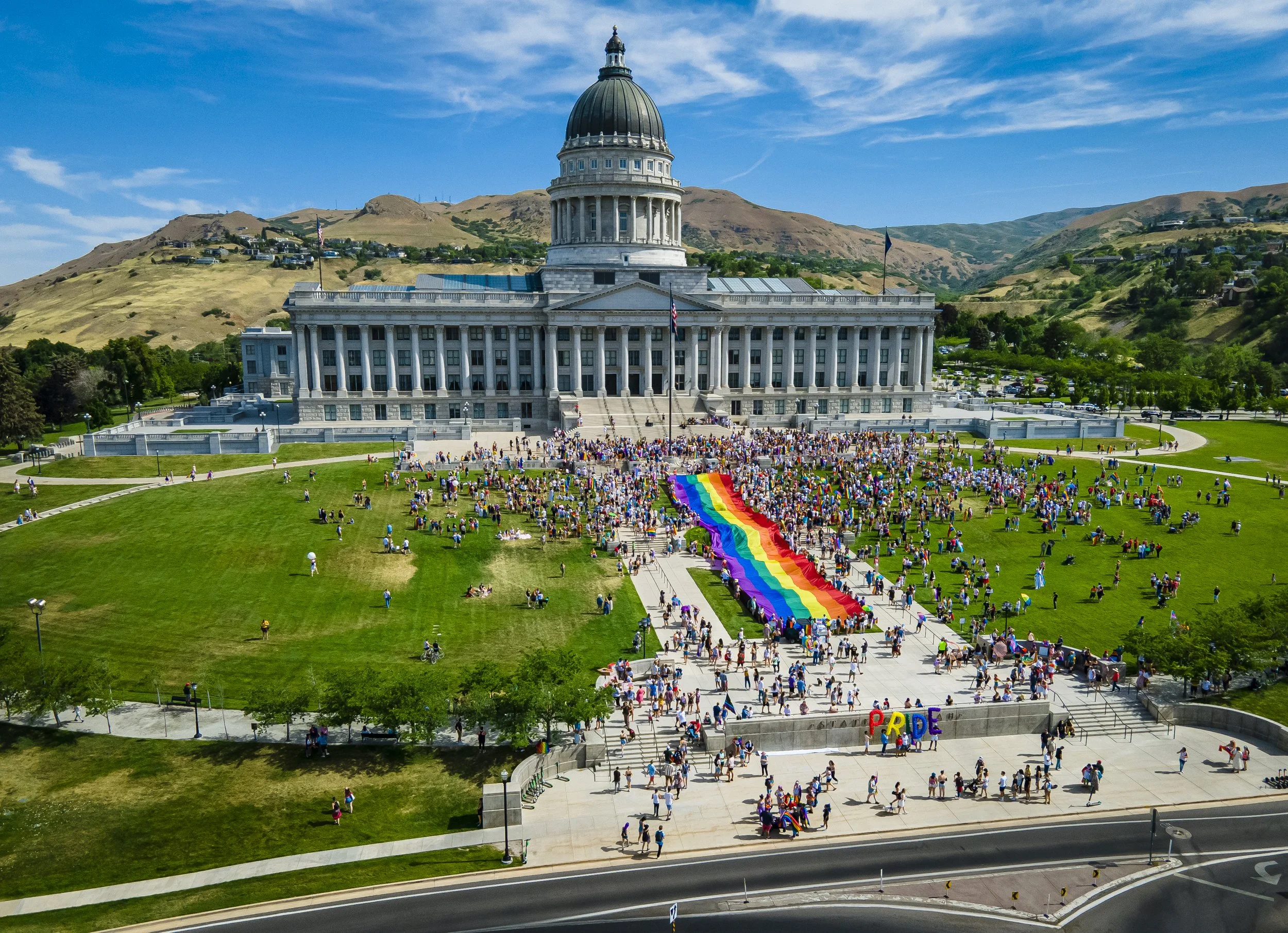 Attendees unfurl a pride flag at the start of the Rainbow March and Rally, hosted by the Utah Pride Center in Salt Lake City, Utah, on Sunday, June 6, 2021. The march began at the Utah State Capitol and proceeded through downtown Salt Lake City.