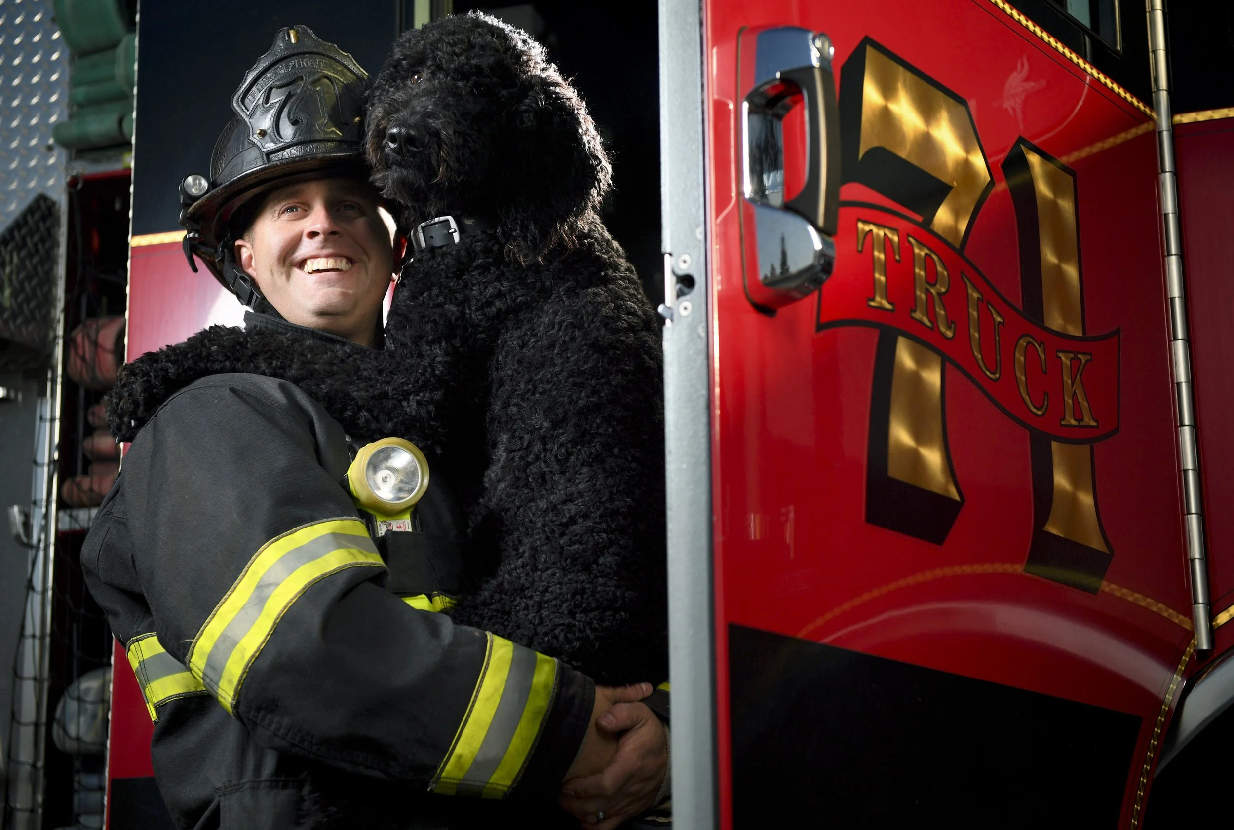 Arson, the Pleasant Grove Fire Department's dog, poses for a portrait in the arms of firefighter Shawn Sandberg on Wednesday, Dec. 28, 2016, at the Pleasant Grove Fire Station in Pleasant Grove, Utah. Arson is a 1-year-old Goldendoodle, and he occasi