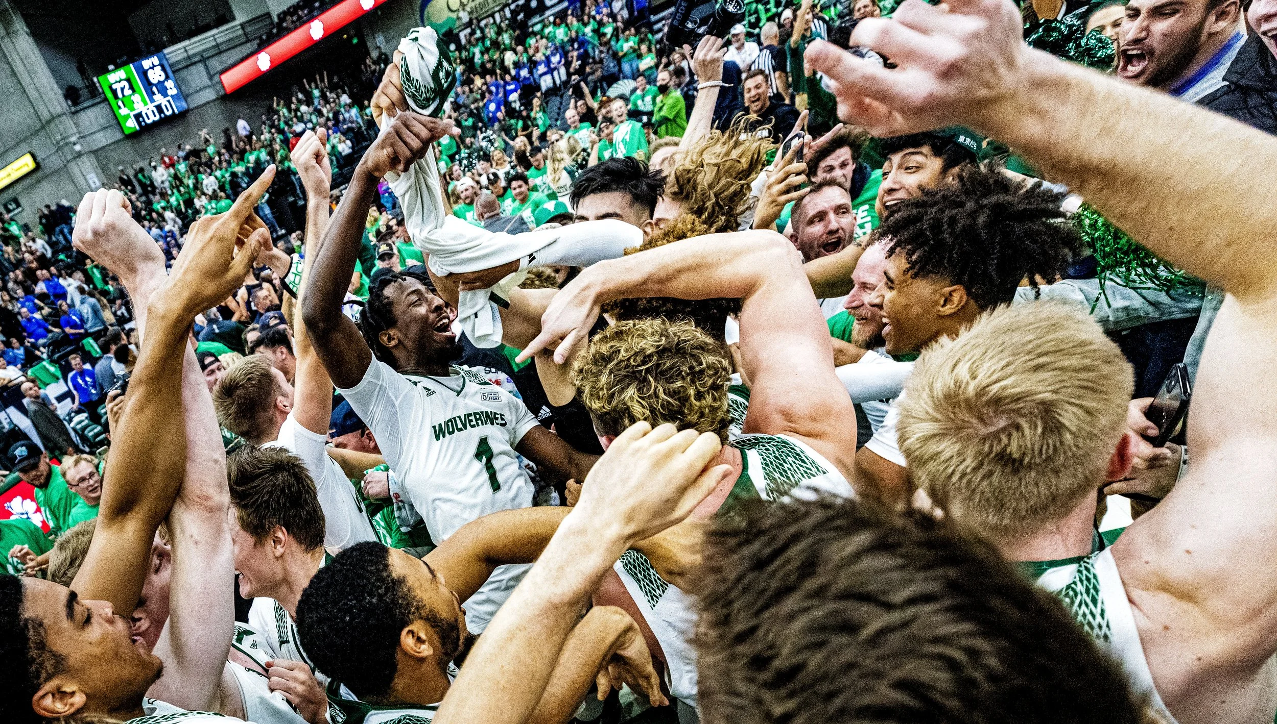 Utah Valley University guard Le'Tre Darthard (1) celebrates with his teammates after defeating in overtime the No. 12 ranked Brigham Young University Cougars in the Crosstown Clash at the UCCU Center on the campus of UVU in Orem, Utah, on Wednesday,