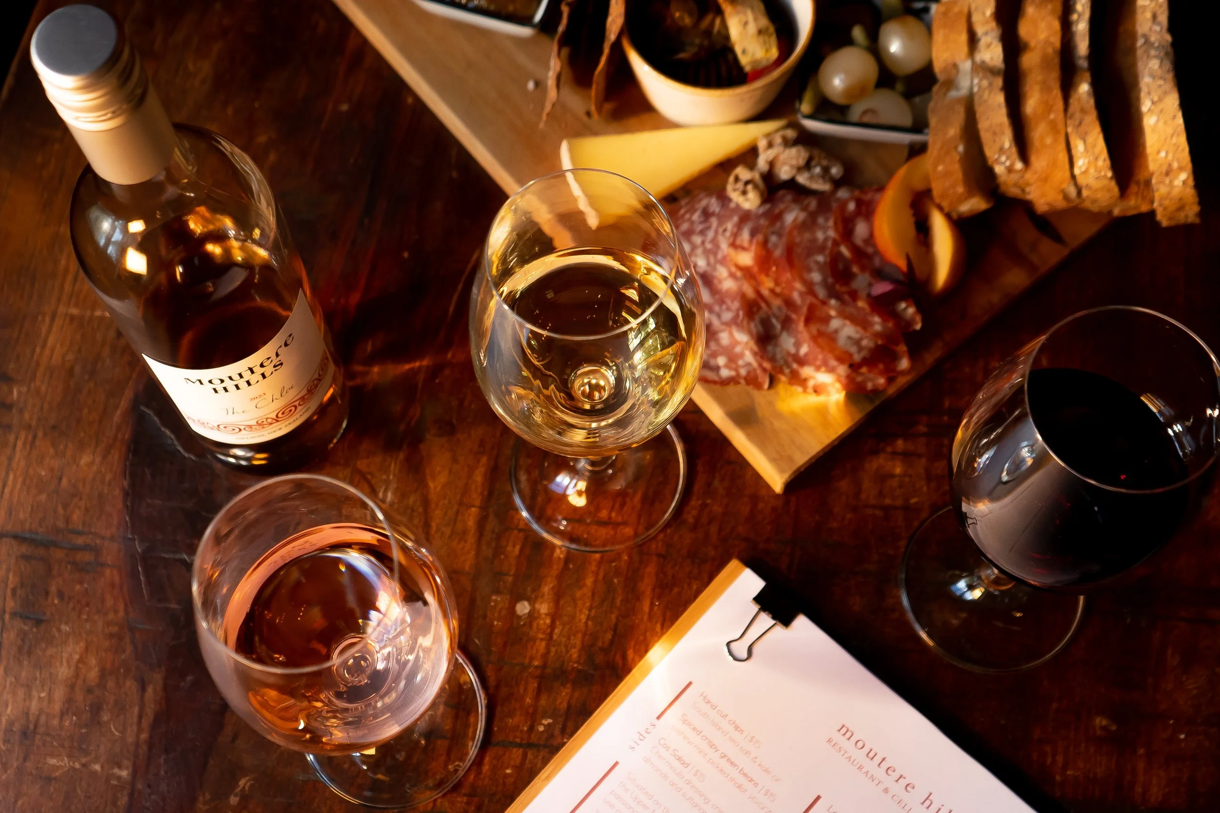 Two glasses of wine and antipasto platter on table 