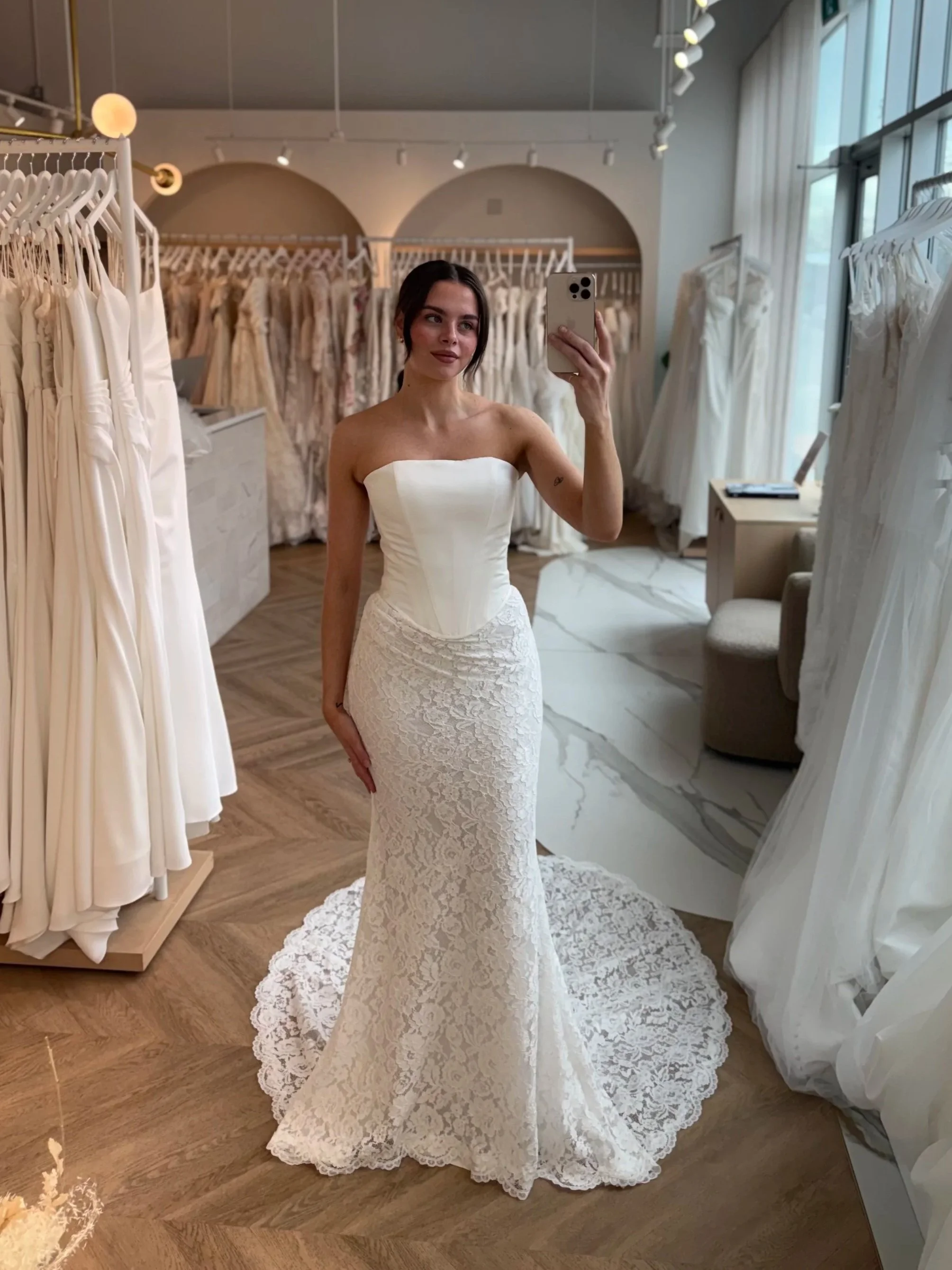 Beautiful  bride wearing a clean bodice fitted lace skirt Basque waist at The Bridal Boutque.