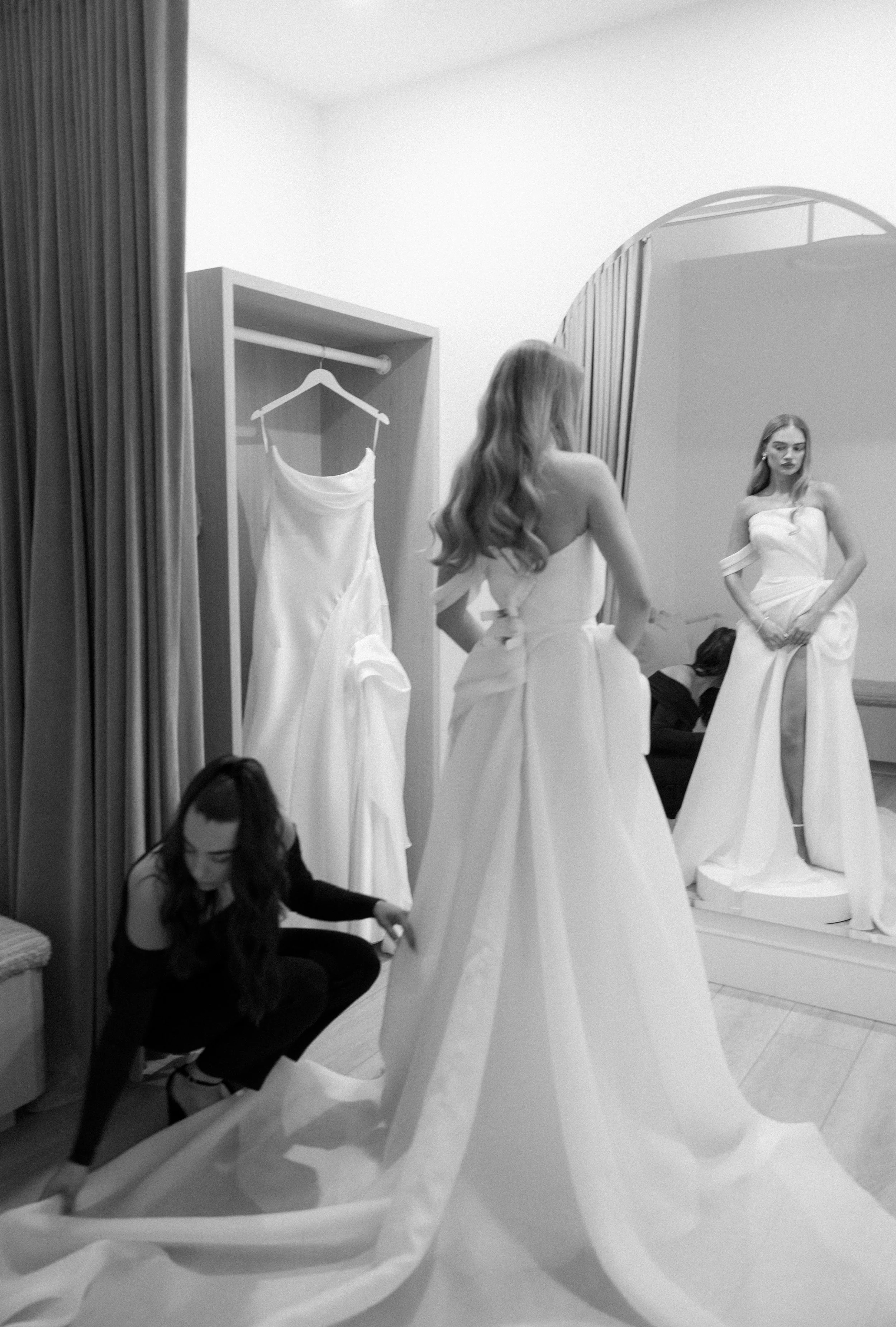 A beautiful bride at The Bridal Boutique trying on wedding gowns with her stylist