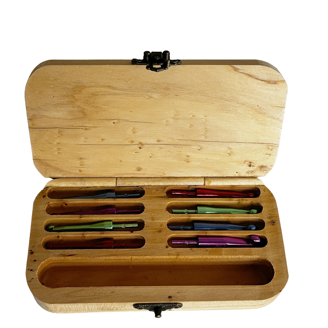 Inside view of wooden Crochet Hook Box made out of Macrocarpa by Wildwood Pens. It has a celtic knot engraved on the lid and shows eight interchangeable hook of different sizes