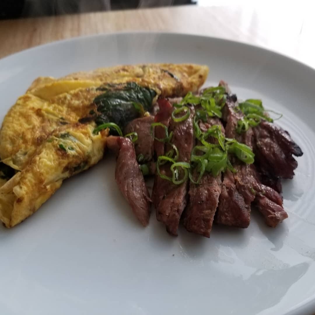 Smoke-grilled Carne Asada (skirt steak) with a Mushroom &amp; Spinach omelette- skirt steak marinated in fresh squeezed orange &amp; lime juice, cilantro, and seasoning, then grilled/smoked over hickory chips. Served with an omelette made of Reddiegg