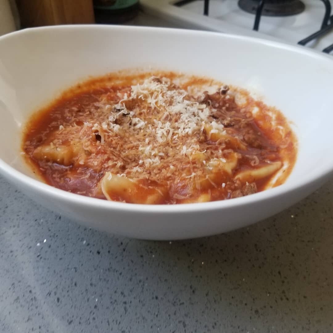Beef and pork Italian sausage raviolis - homemade raviolis stuffed with a mixture of 80/20 ground beef, Italian pork sausage, and fresh basil. Served with a turkey meat sauce and topped with freshly grated parmesan. #italianfood #ravioli #beefravioli