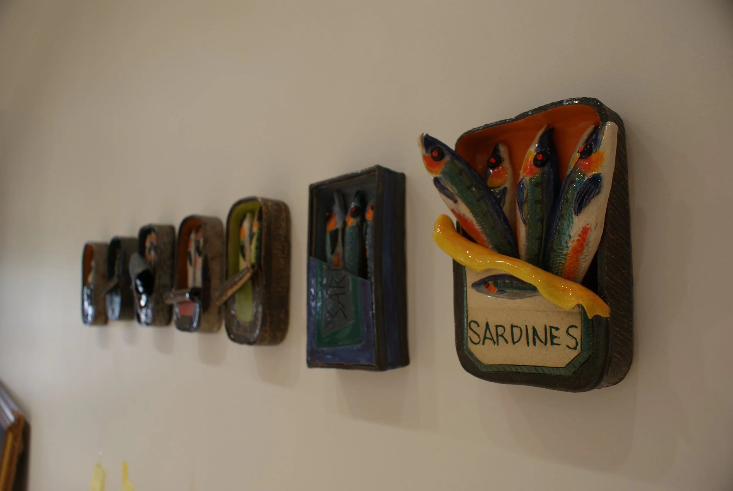 Sardine tin wall art on display at Gasper Arts Center.jpg