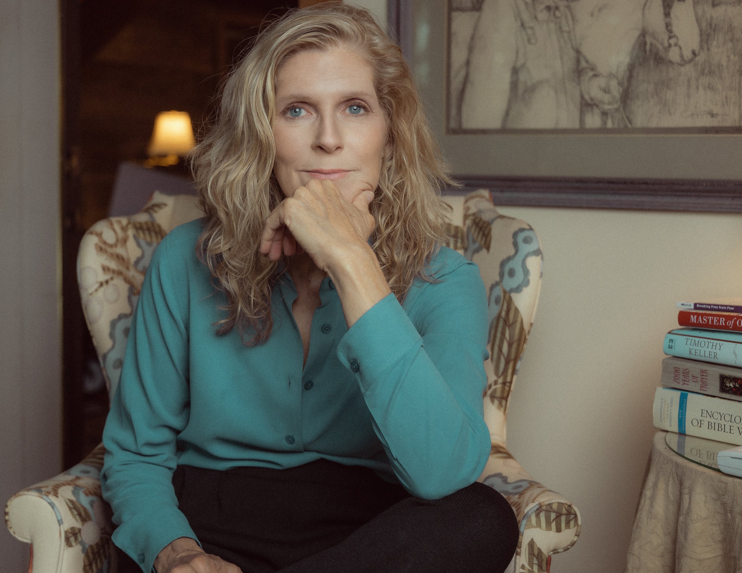 When the Flowers Die author, Renee Leonard Kennedy, sitting in a chair.