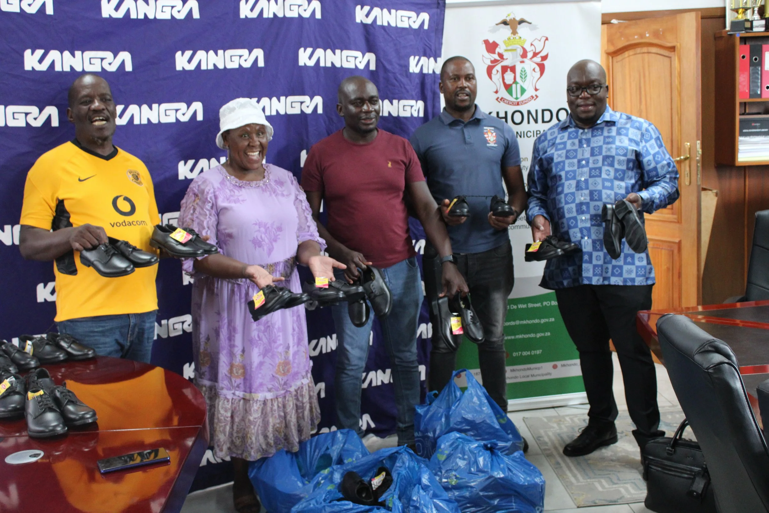 Kangra supports education by providing 100 pairs of school shoes