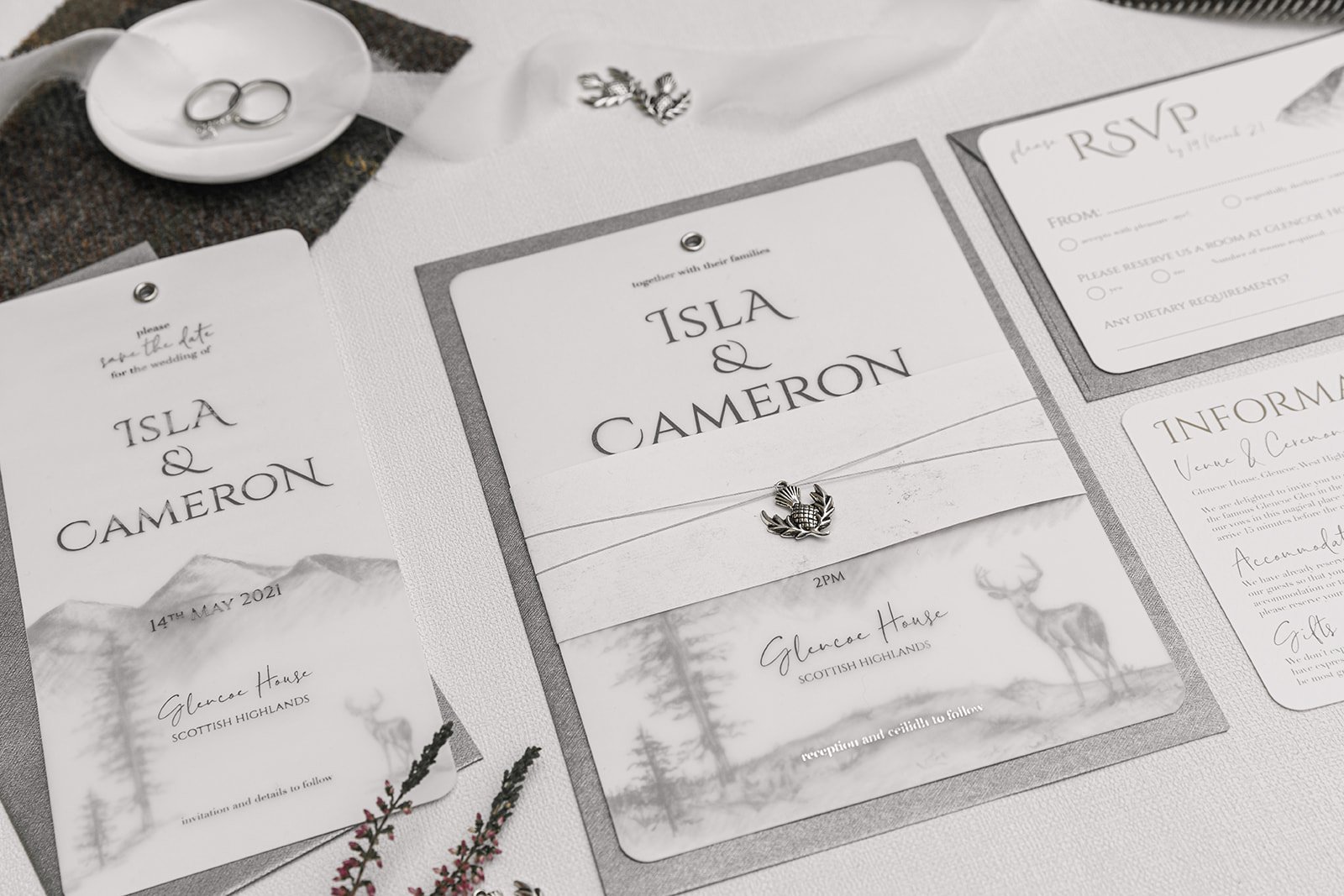 Silver-foiled Highland Romance Charmed Invite™ with silver thistle charm, and 'Silver Mist' envelopes