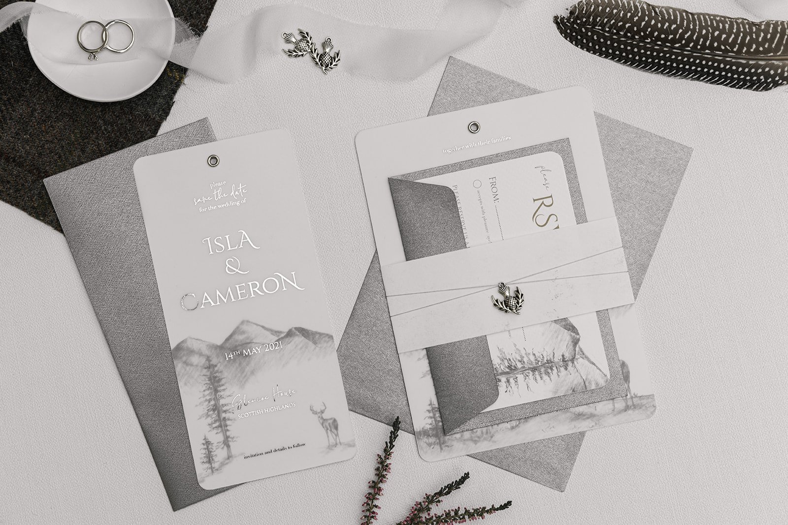 Silver-foiled Highland Romance Charmed Invite™ with silver thistle charm, and 'Silver Mist' envelopes