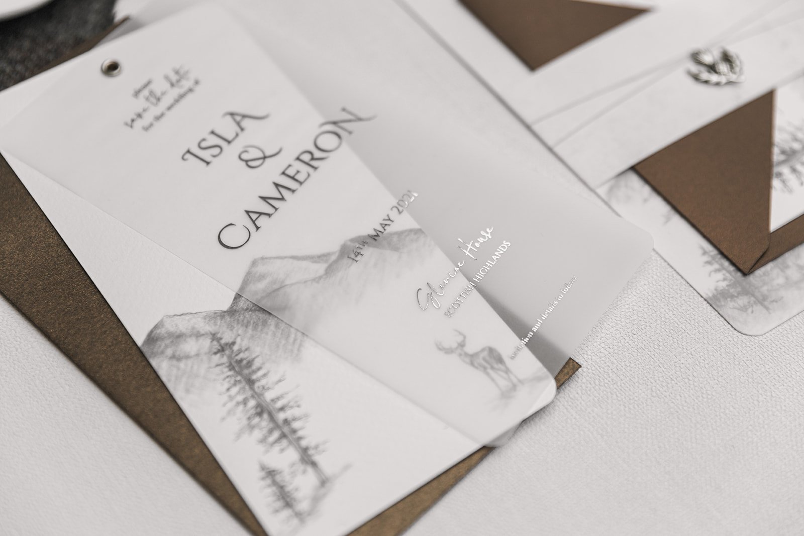 Silver-foiled Highland Romance Save the Date showing vellum layer