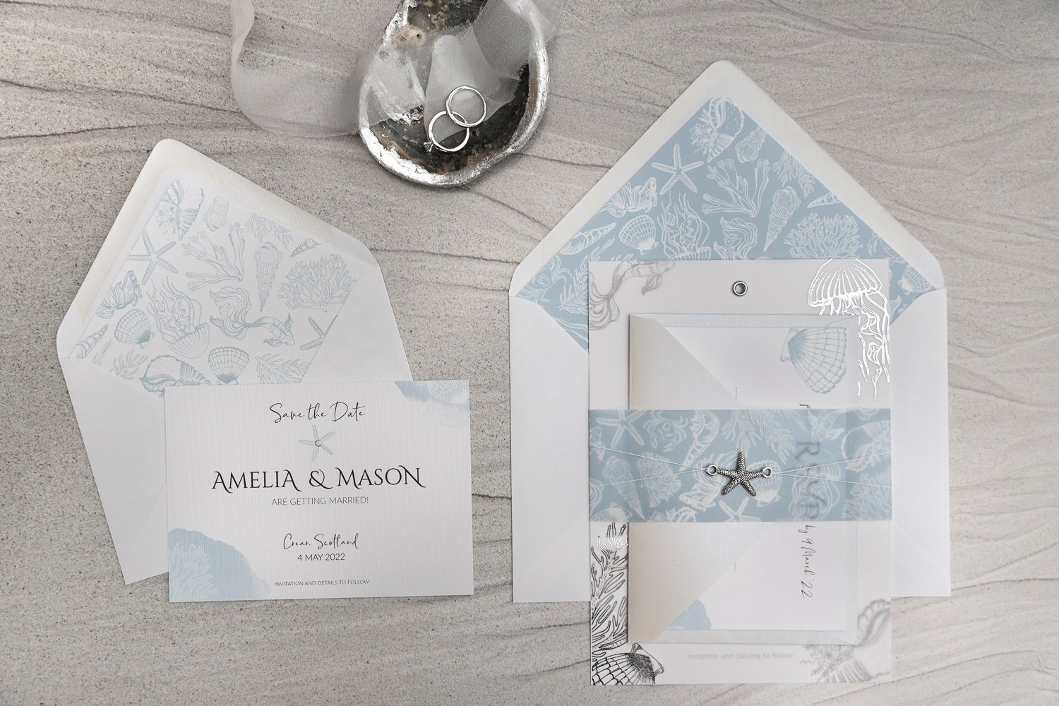 Beachcomber Charmed Invite™ with silver starfish charm and Coast Blue vellum belly band