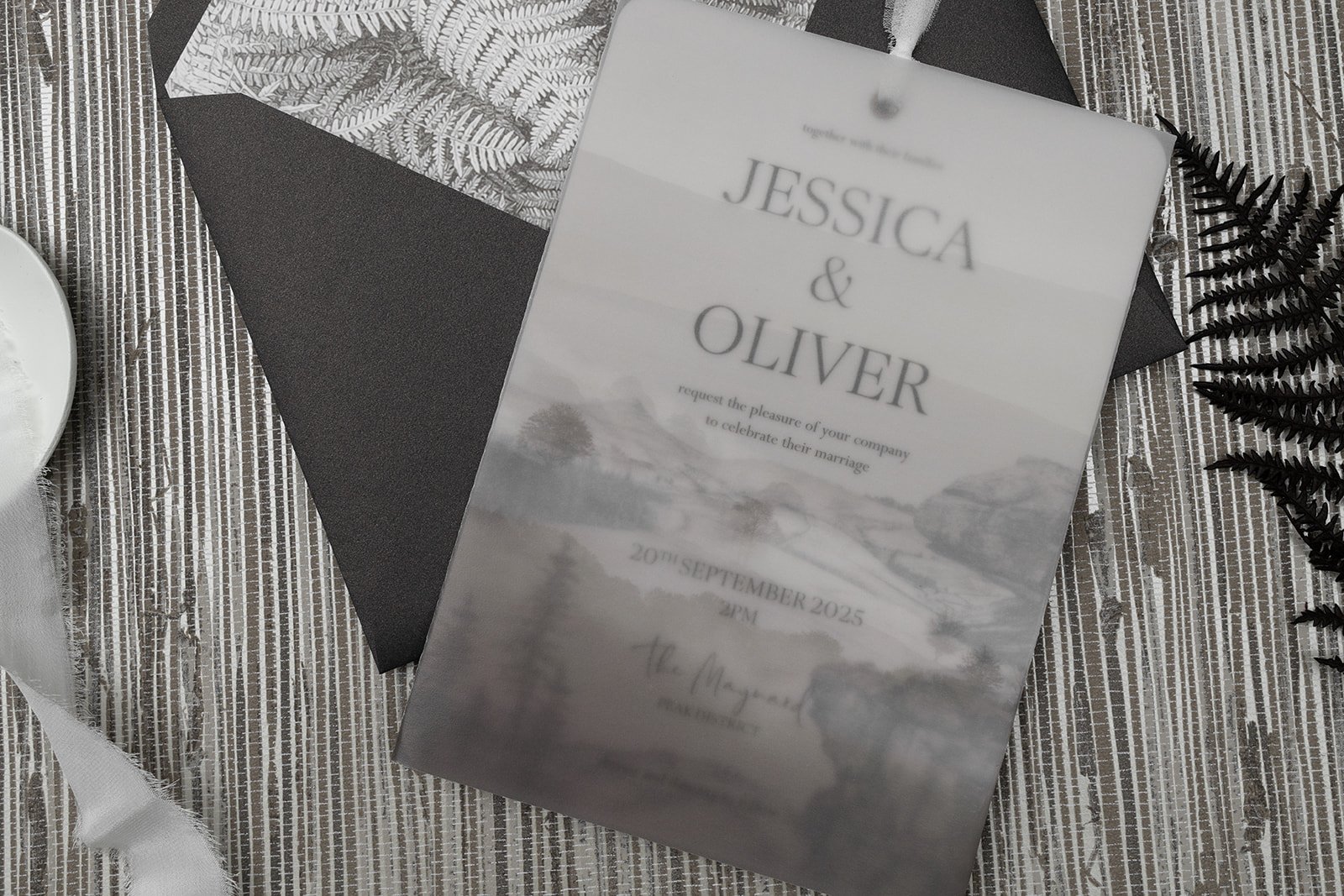 Majestic Peak wedding invitation with Peak District landscape vellum pocket in 'Bronze Sepia', shown with pearlescent 'Bronzed Peat' envelope and bronze ferns liner.