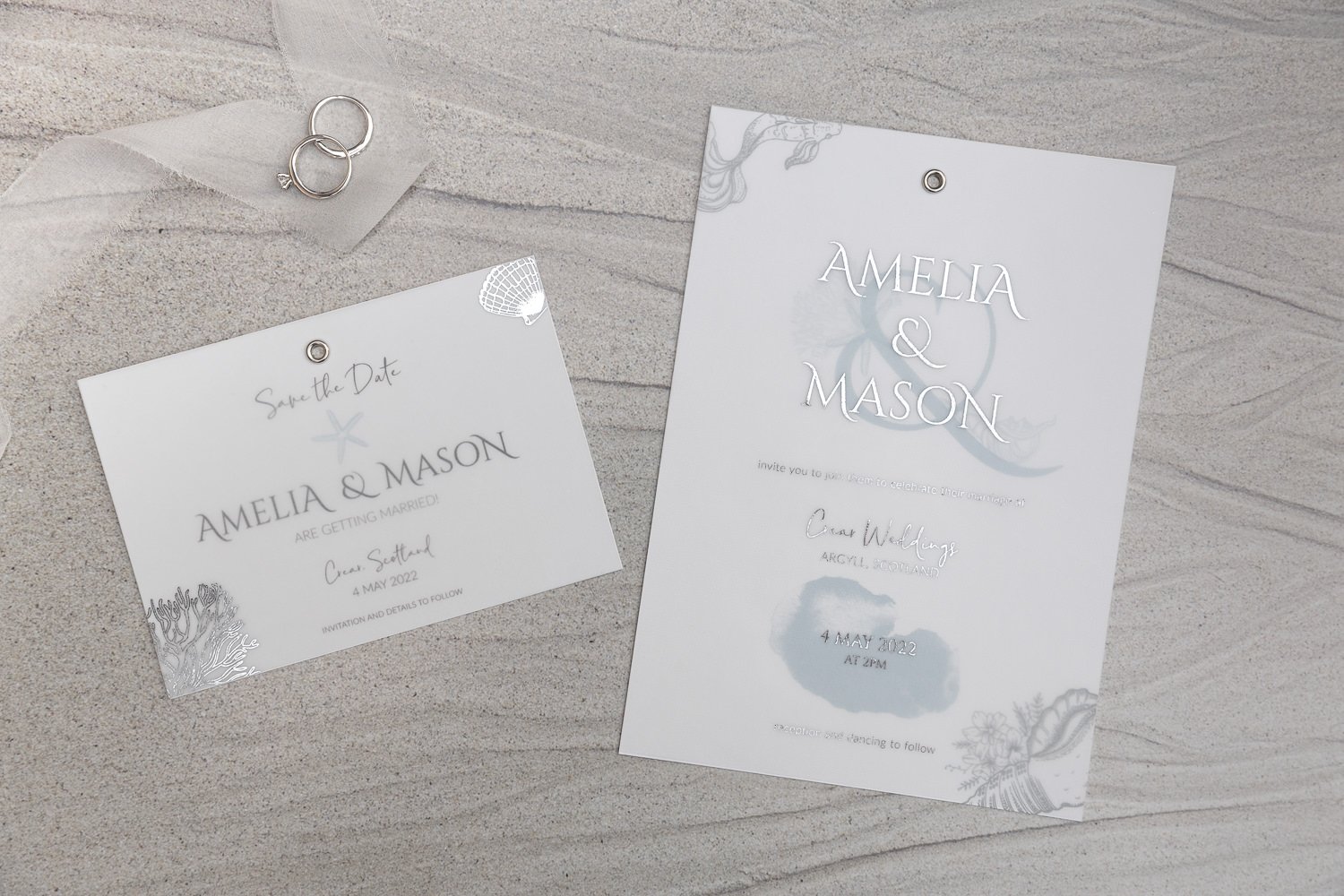 Silver-foiled vellum overlays in sea illustrations (Save the Date) and foiled text (Day invite)