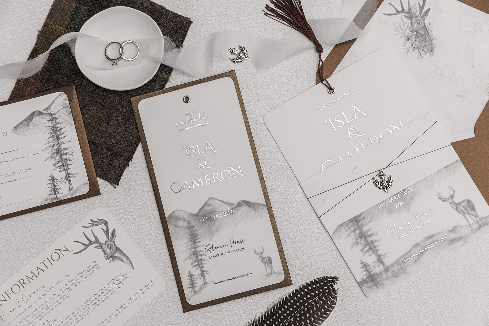 Silver-foiled Highland Romance Charmed Invite™ with silver thistle charm, and lined 'Highland Bronze Shimmer' envelopes