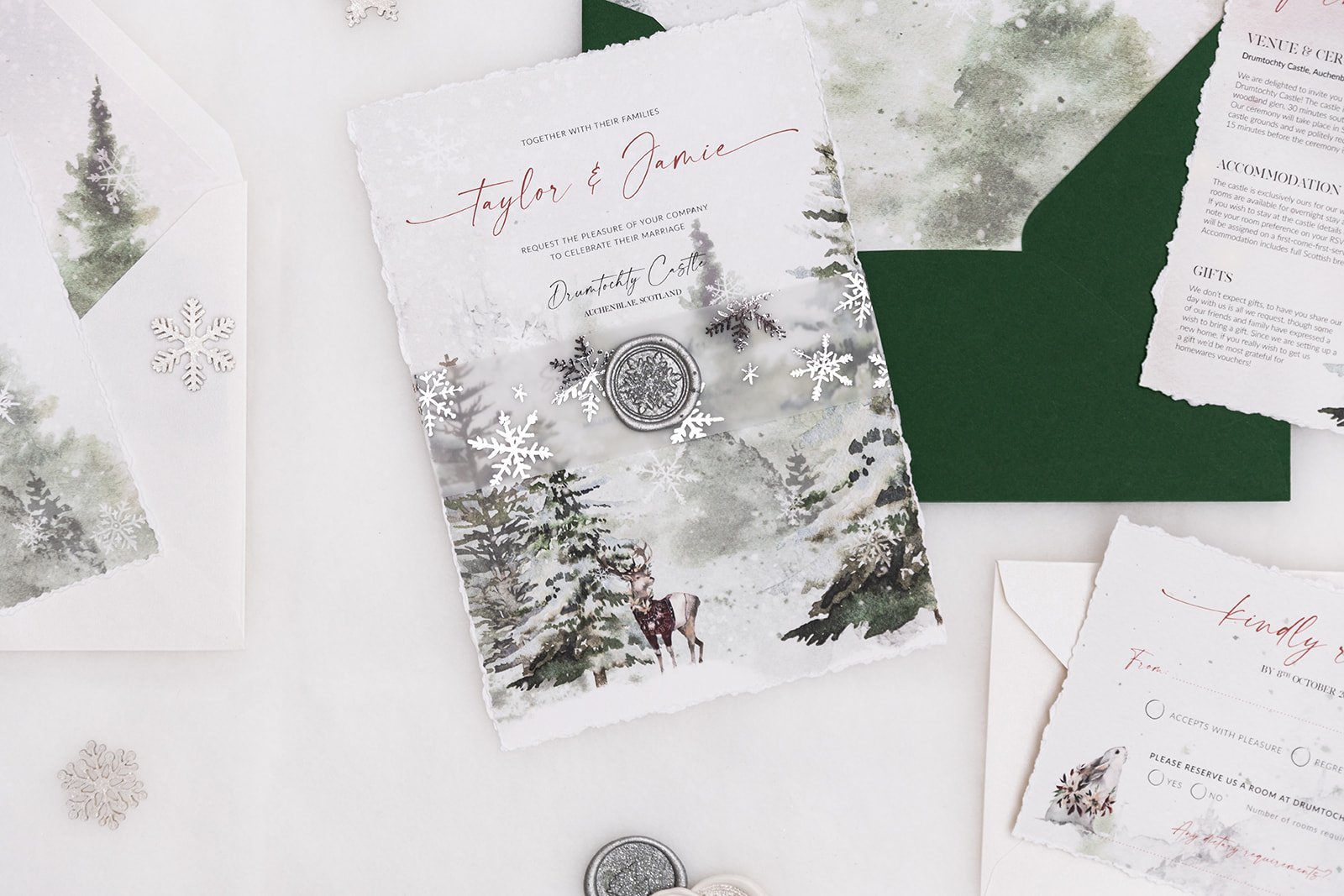 Winter Frost wedding stationery with envelopes in 'Forest Green' and 'Frost White' with silver-foiled vellum belly band and Silver wax seal 