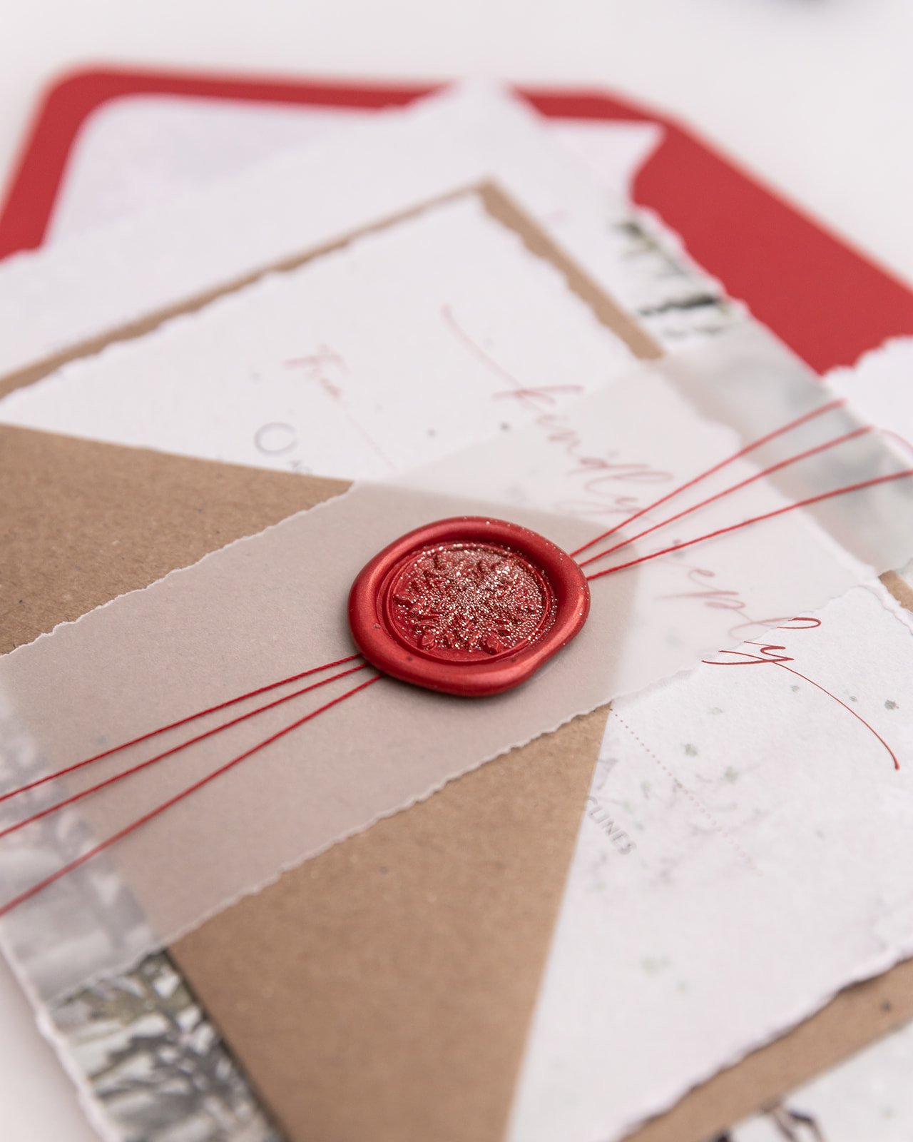 Day invite and RSVP bound with plain vellum deckle-edge belly band and glittered wax seal in 'Berry'