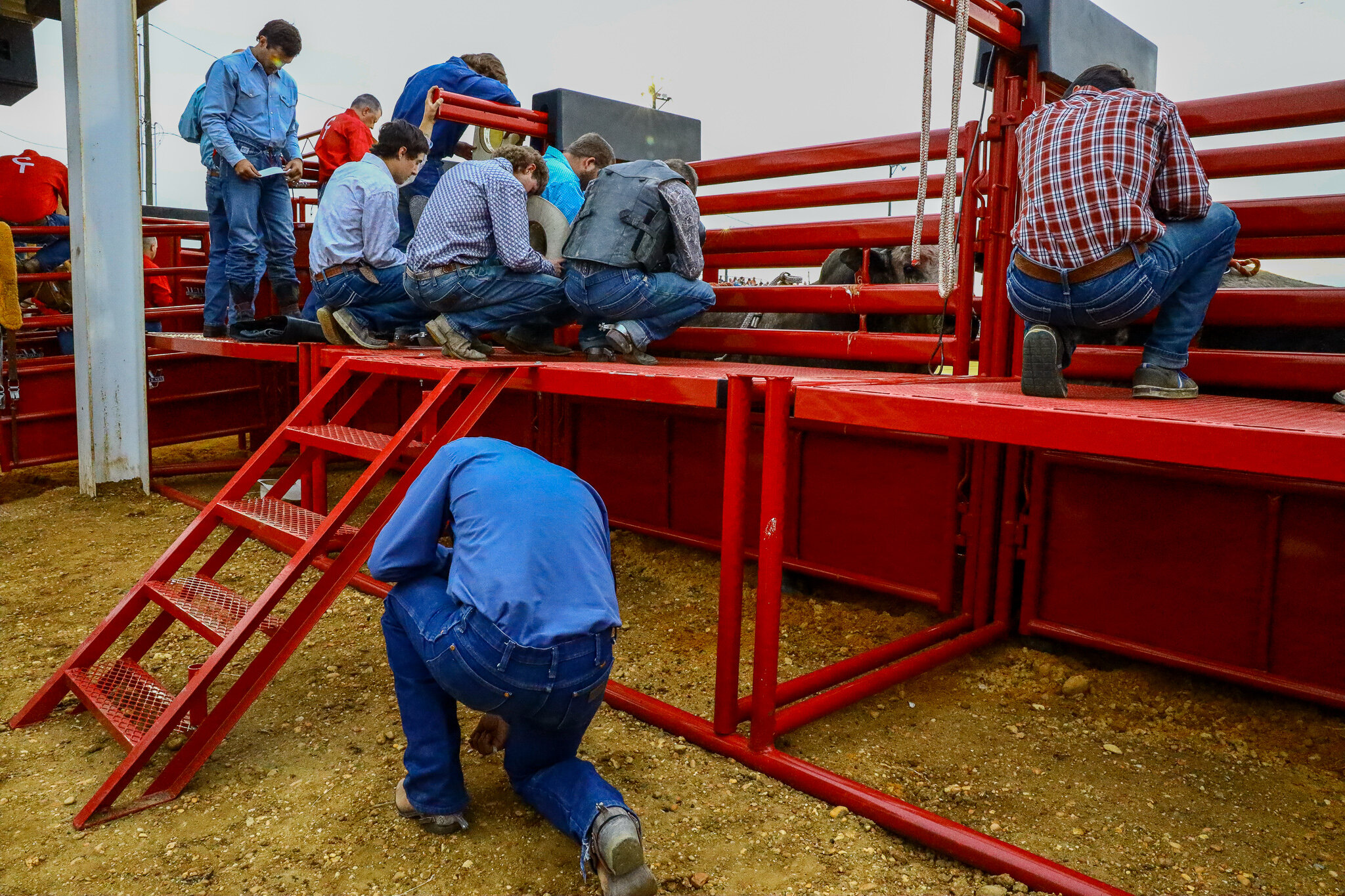 Prayer is a pillar of rodeo culture. Knowing the risk of devastating injury, riders find solace and comfort in prayer prior to the evening's events.