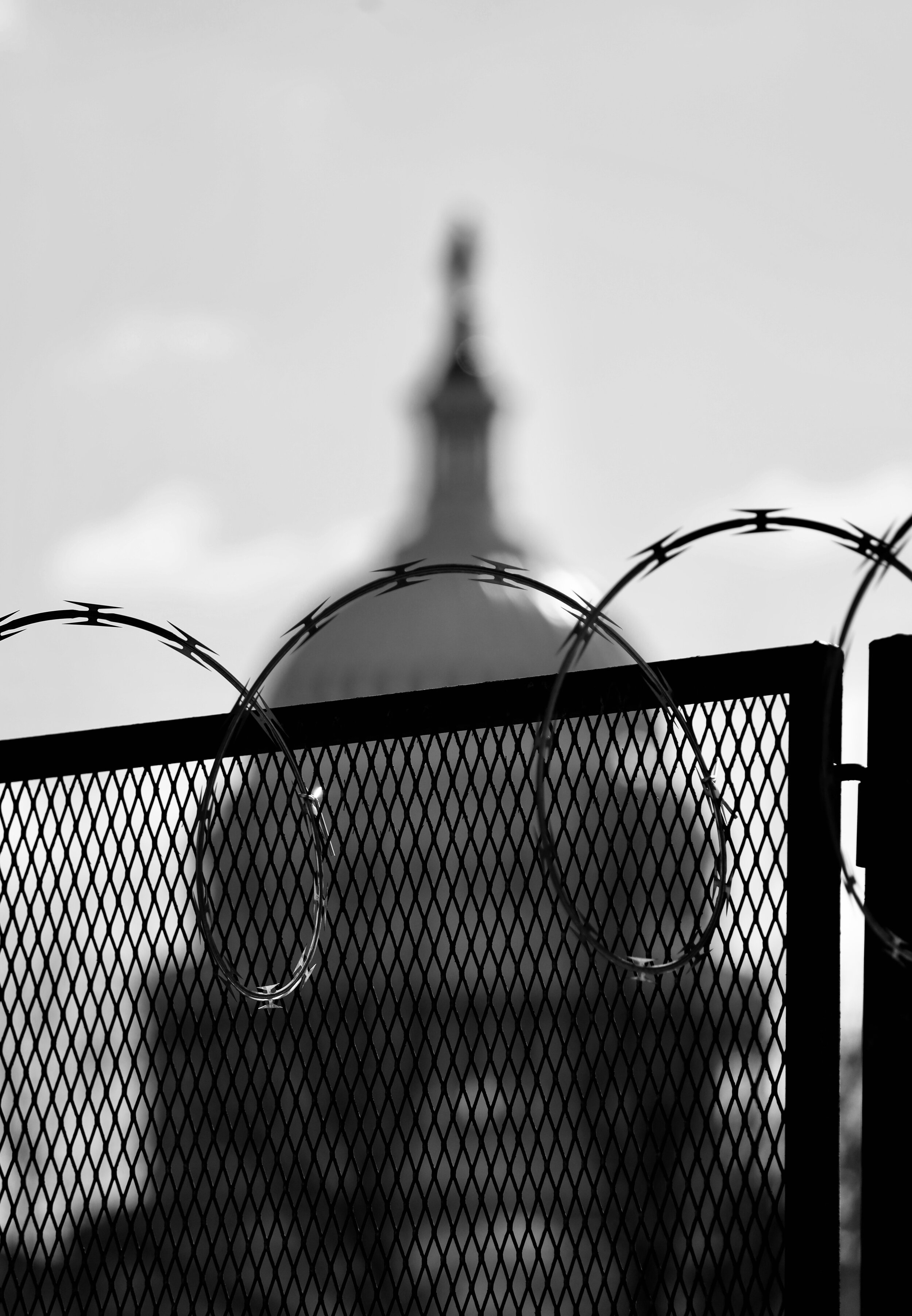 The United States Capitol, seen from Constitution Avenue, on March 4, 2021. Razor wire fencing surrounds the entire Capitol grounds nearly two months after the January 6th insurrection.