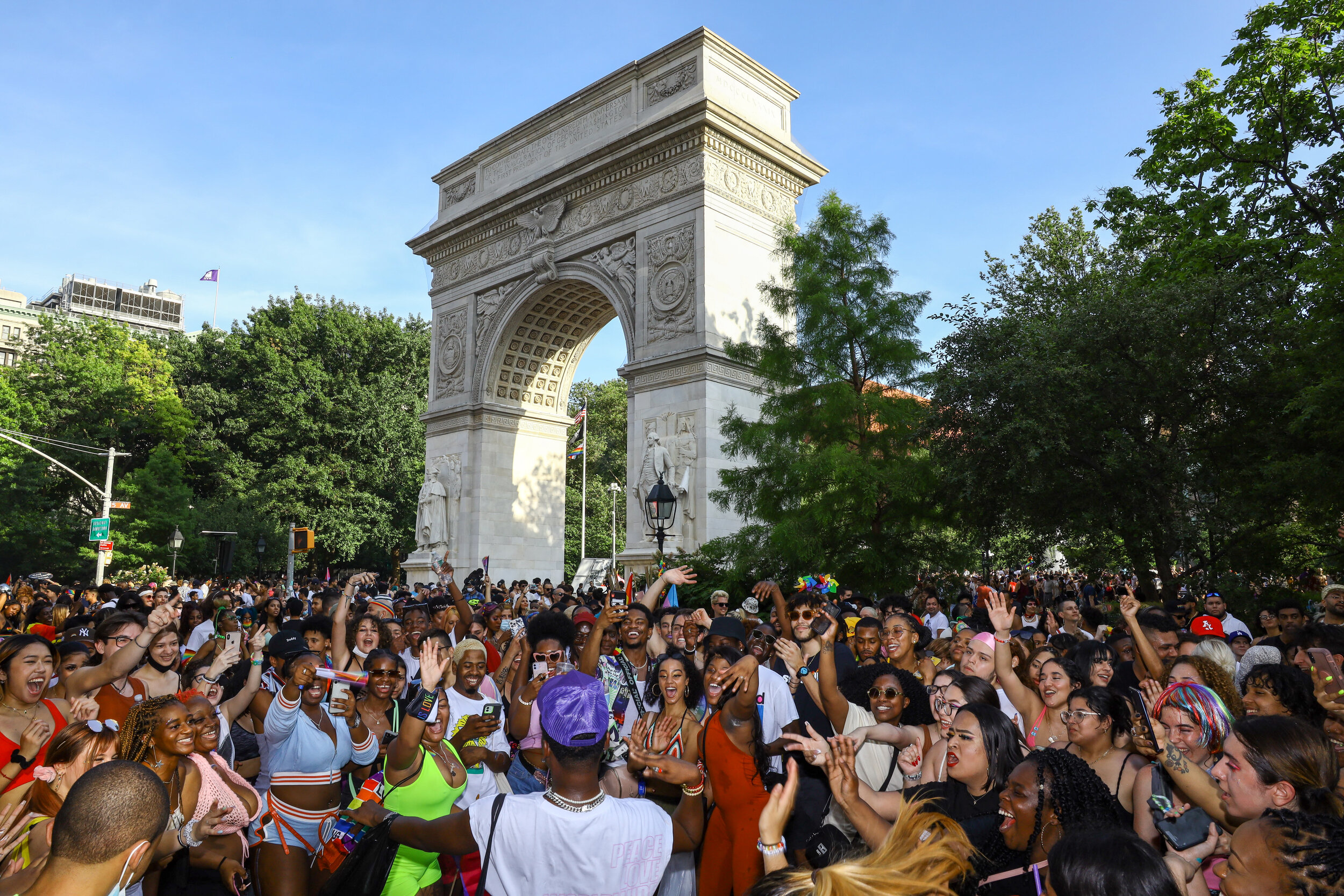 A crowd of people dance in the street during the NYC Pride March at Washington Square Park on Sunday, June 27, 2021.