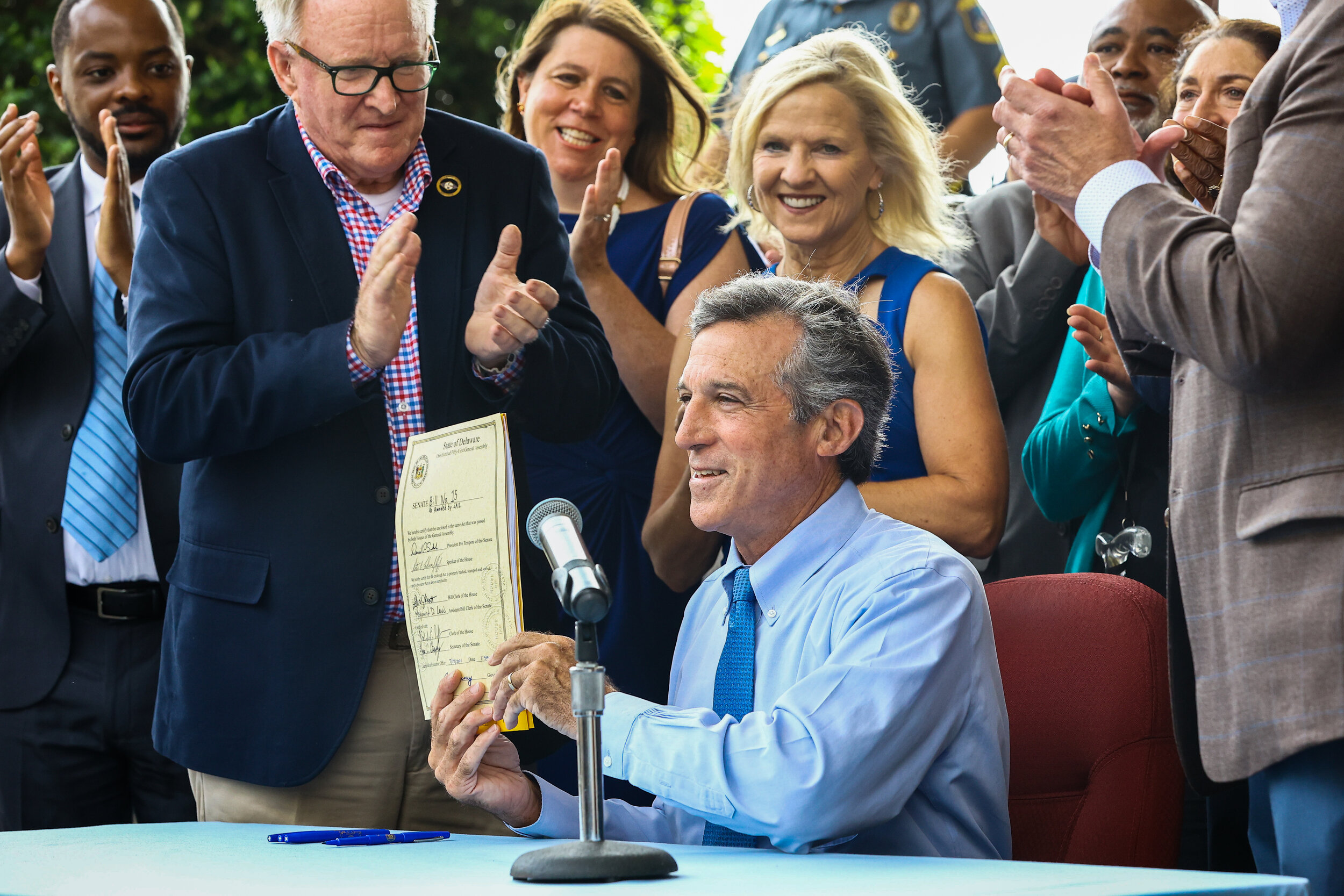 Delaware Governor John Carney signs Senate Bill 15 in Wilmington, Delaware on Monday, July 19, 2021. The bill will raise Delaware's minimum wage to $15 by 2025.