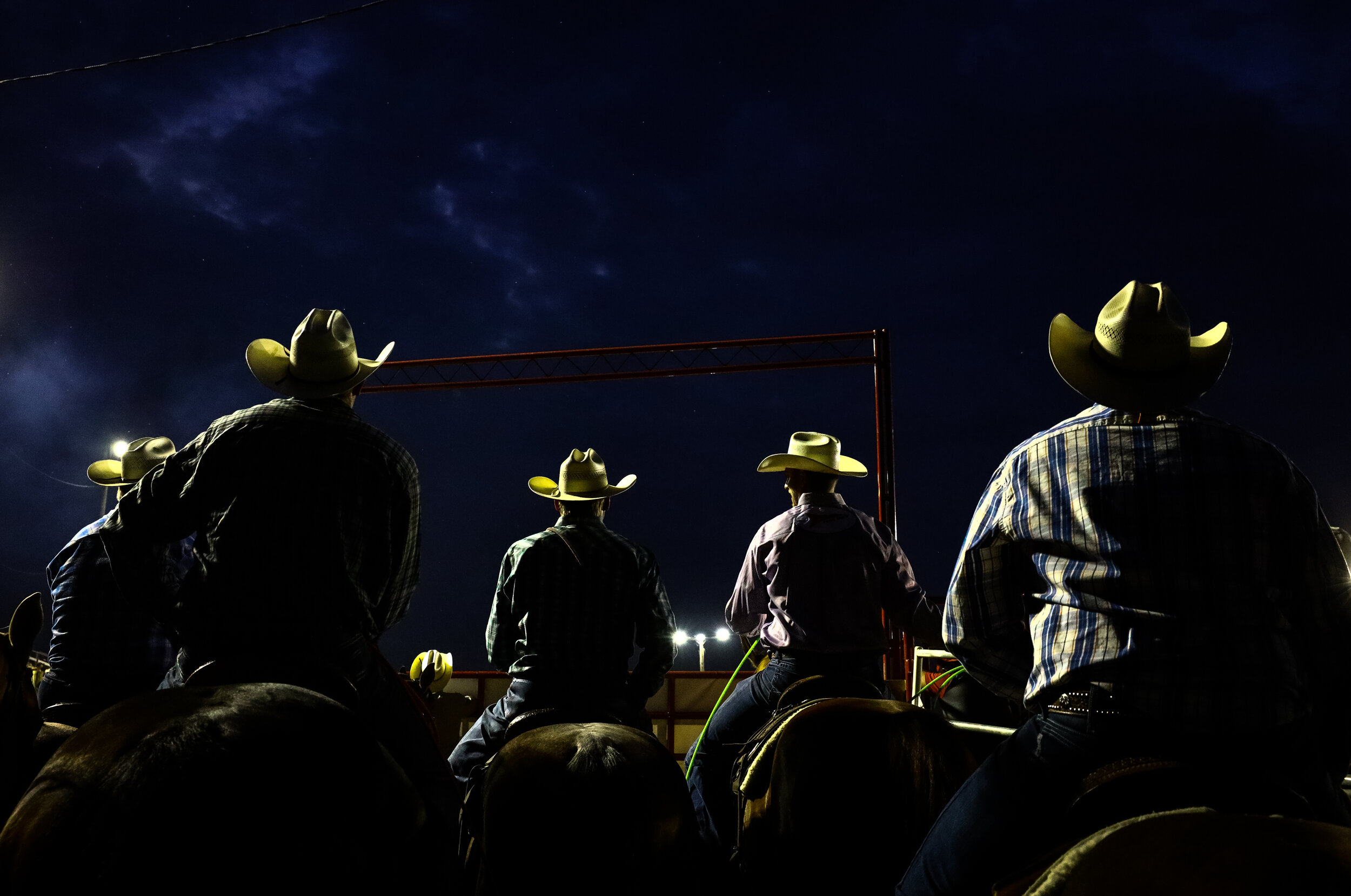Tie-down ropers await their name to be called prior to entering the ring.