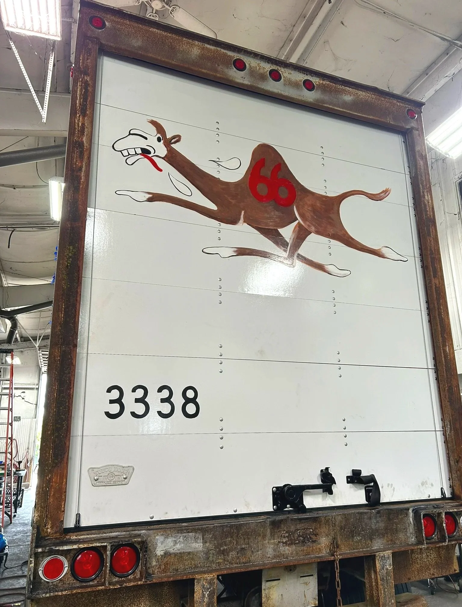 Replica of oringinal logo on replacement rear door of a 1970's Campbell 66 Express semi-truck trailer. Painted in Joplin, Missouri. 2026.