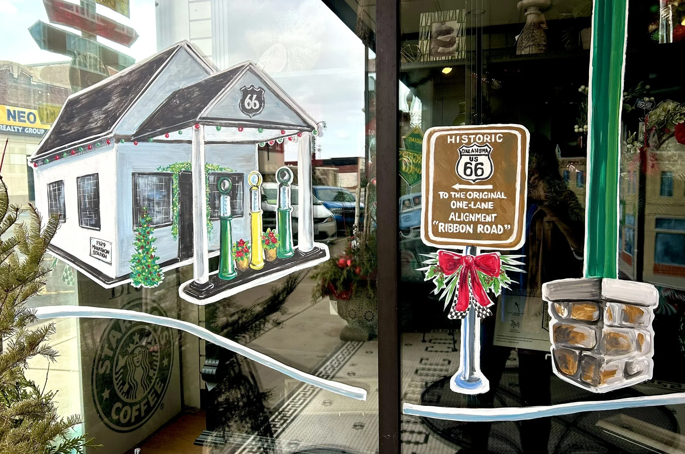Holiday window at Chapters featuring the Historic Ribbon Road and 1929 Marathon filling station. 2025.