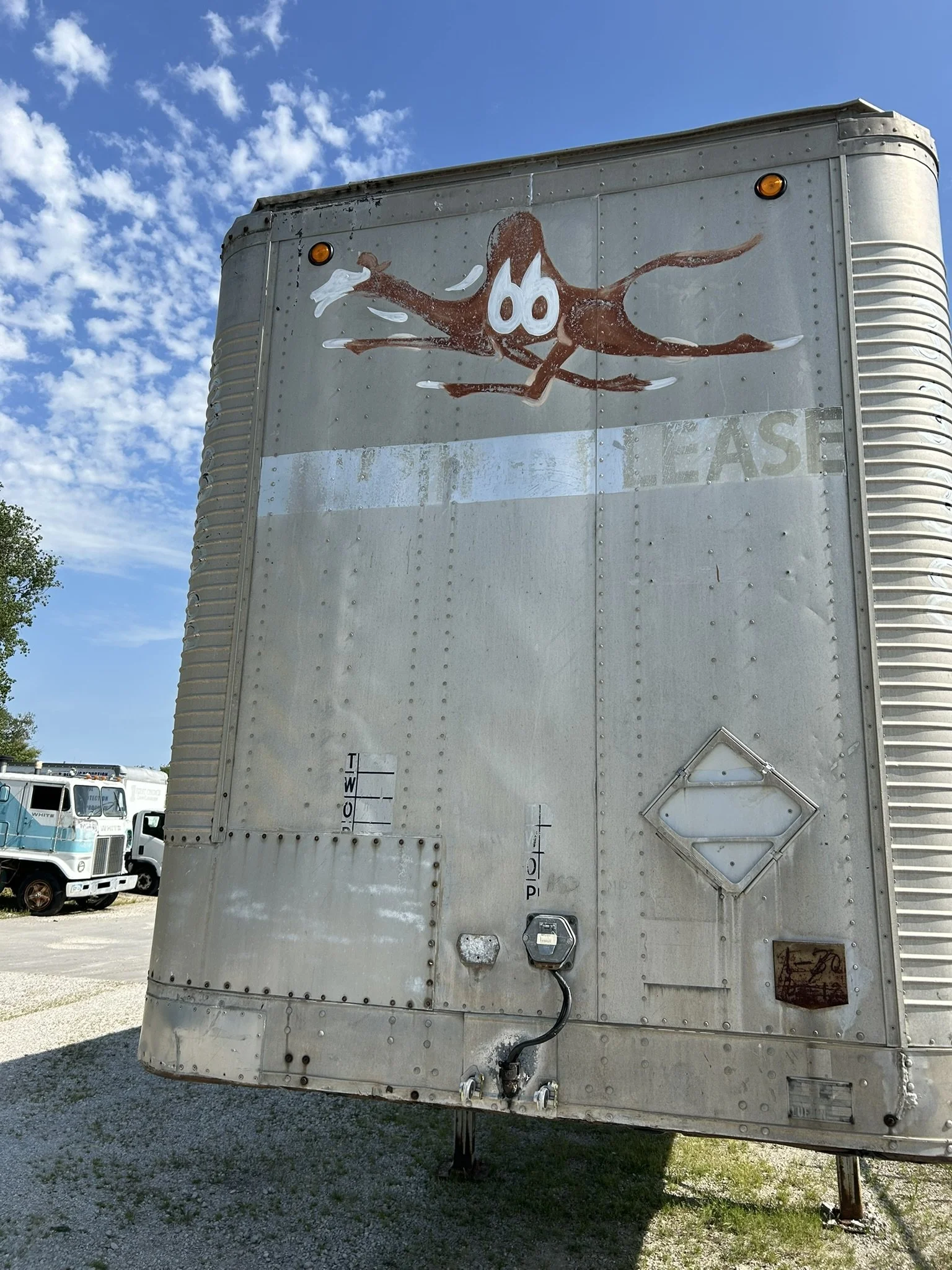 Before Restoration: 1970's hand-painted logo on front of Campbell 66 Express semi-truck trailer. 2026.