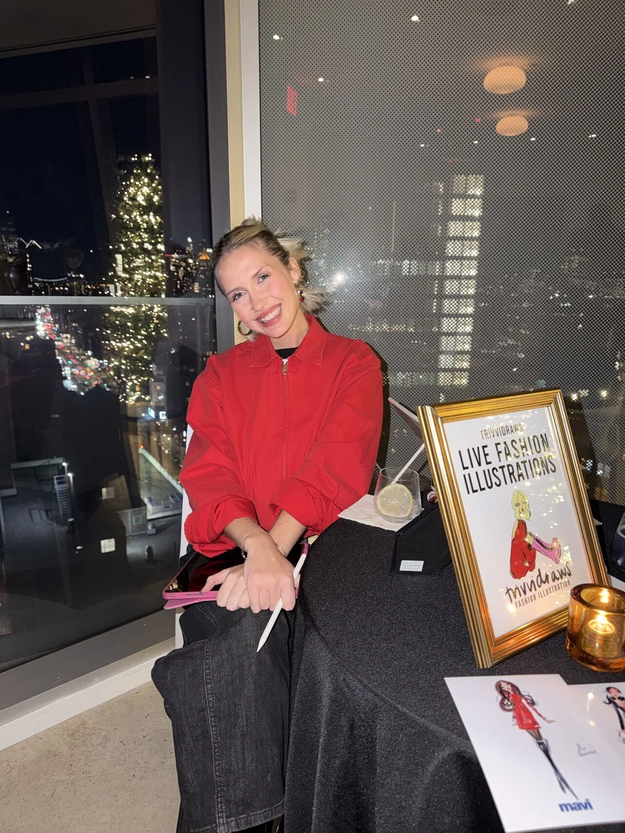trivia hiller at her live sketching station -- drawing at Mavi Jeans holiday party, NYC