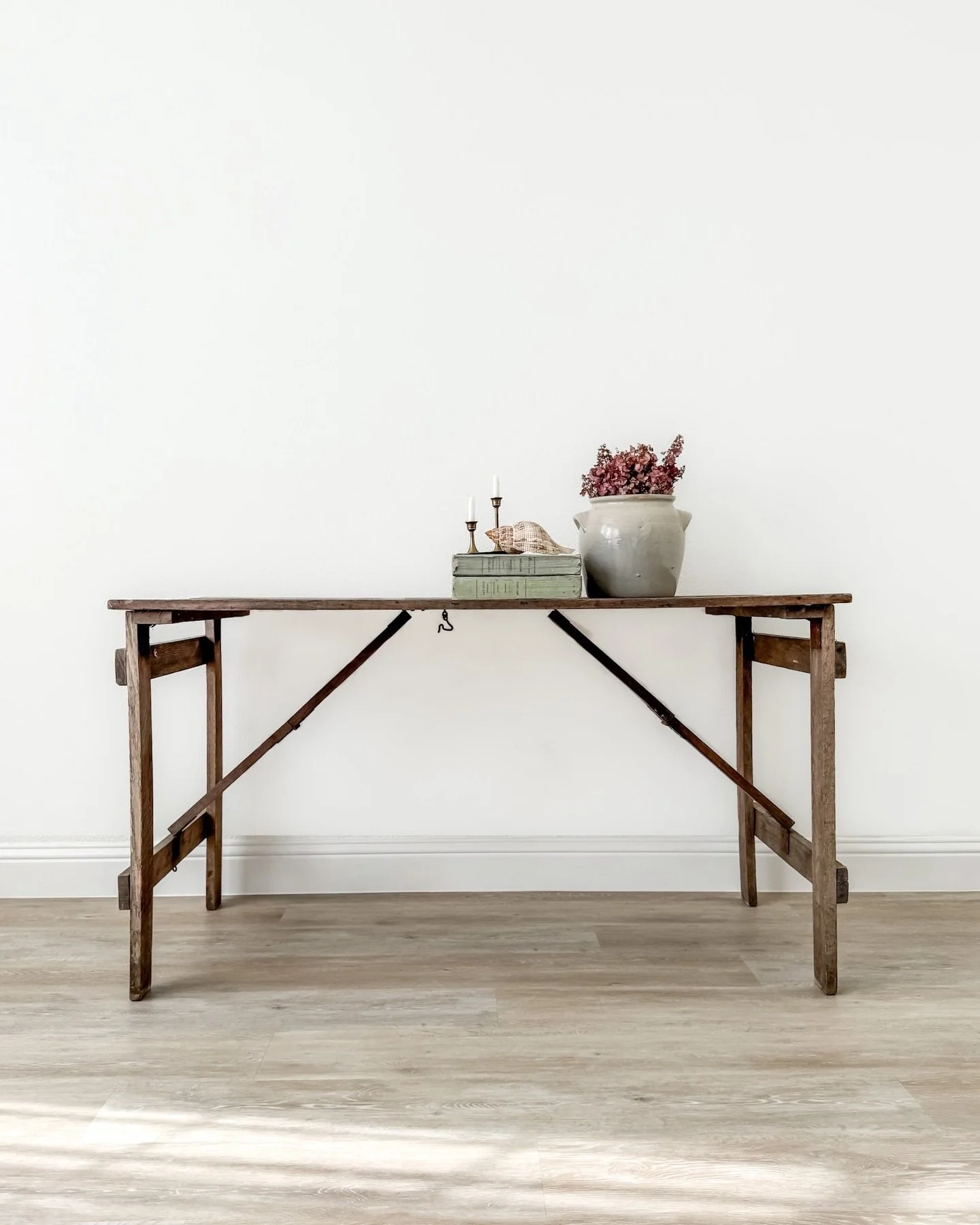[Available] A turn-of-the-century folding table with all the easy, lived-in charm of country fairs and market days. Solid wood, time-worn surface, and legs that collapse flat in one simple motion. Style it as a console, extra dining surface, or servi