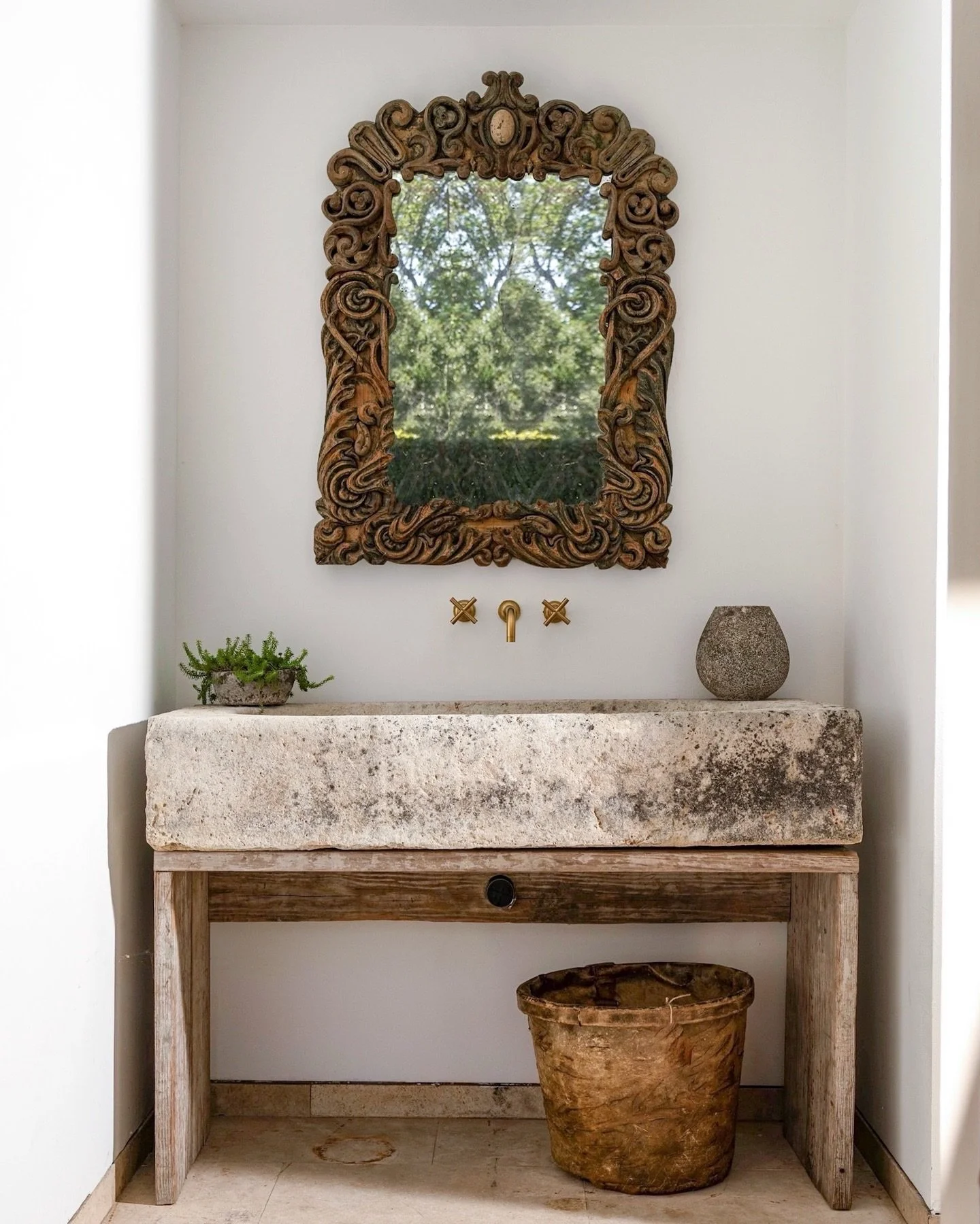 Timeworn beauty at its best&mdash;an ancient stone trough reimagined as a sink, paired with an antique giltwood mirror whose hand-carved details tell centuries-old stories. Where history, texture, and quiet luxury meet. 

Photo and Products Sourced @