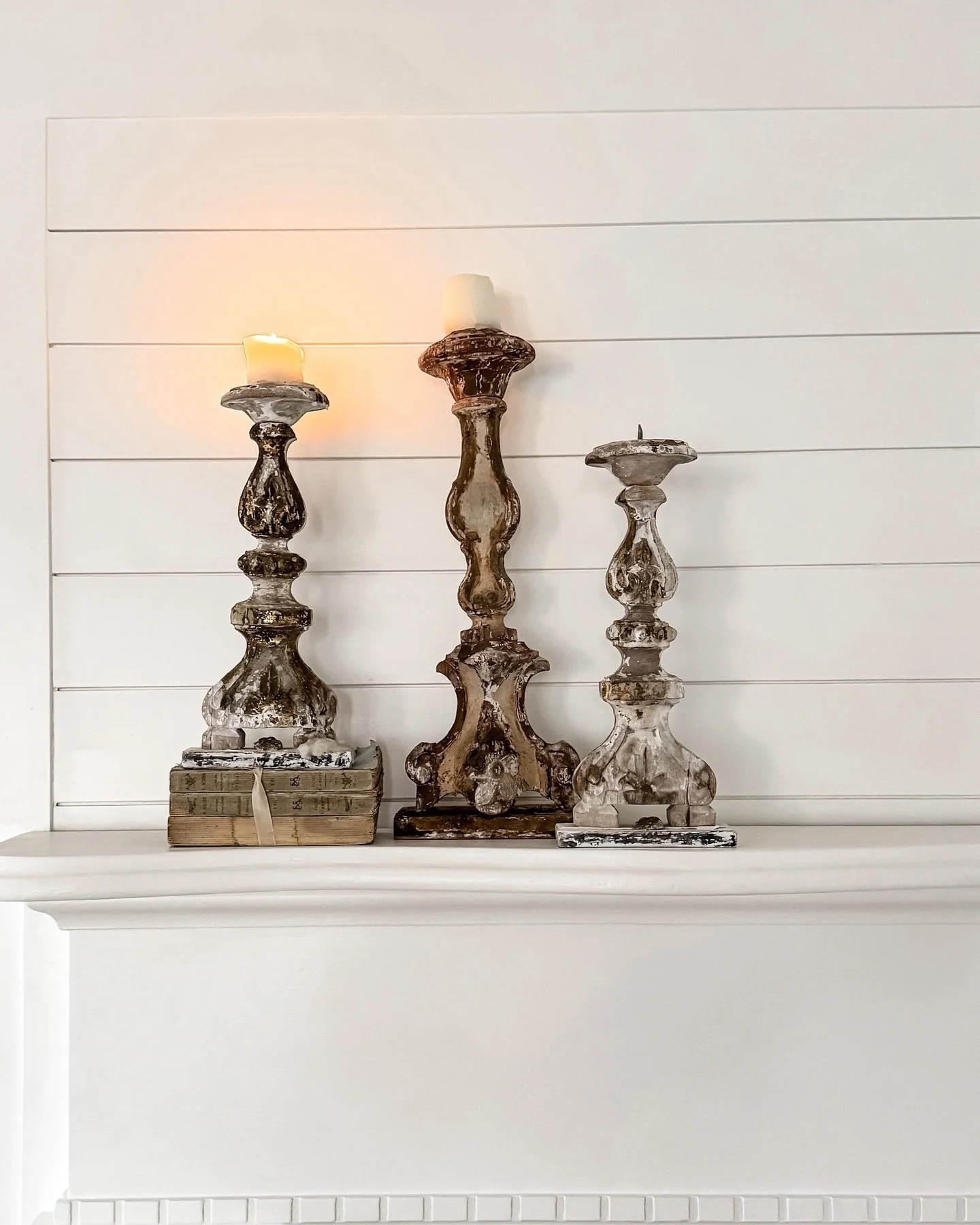 [Available] Early 19th-century French candlesticks with patina only time can make &mdash; carved wood, traces of gilt, and floral details that feel beautifully lived-in.

One-sided by design, meant to rest against a wall or altar, they feel a little 